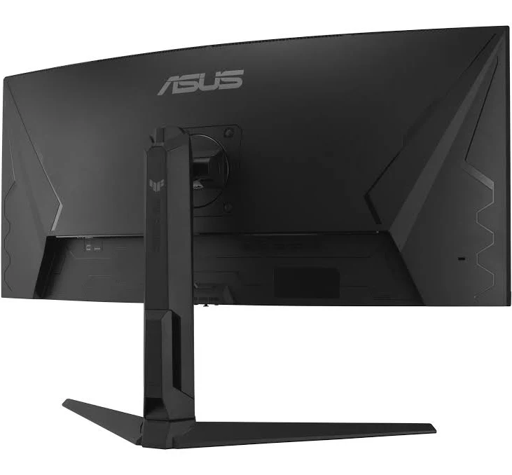 Vista trasera de un monitor curvo ASUS negro. Se ven el soporte y la base. Logotipo de ASUS en la parte superior. El monitor está sobre una superficie blanca.