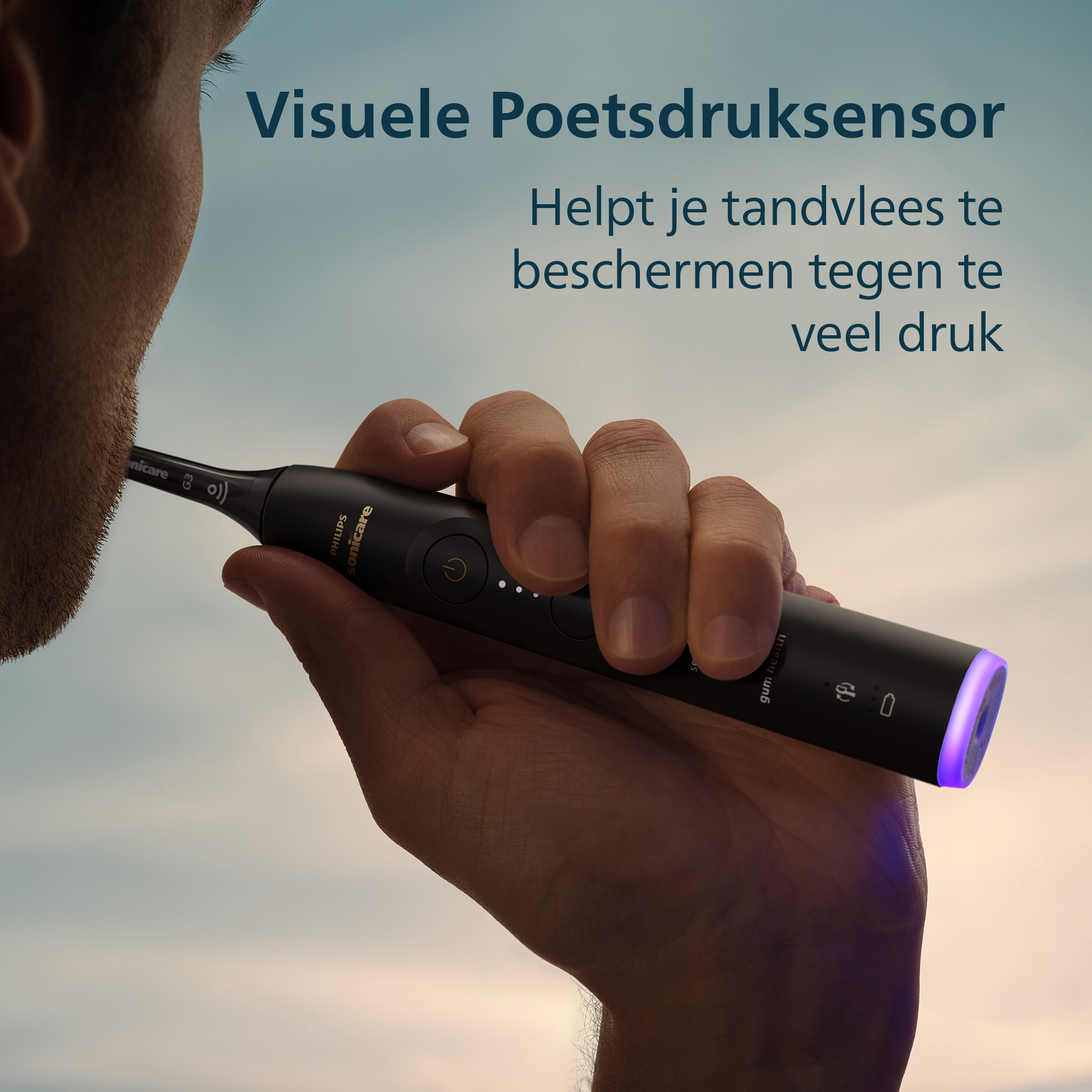 A hand holds a black Sonicare toothbrush. Text says: Visual Pressure Sensor, protects gums from pressure.