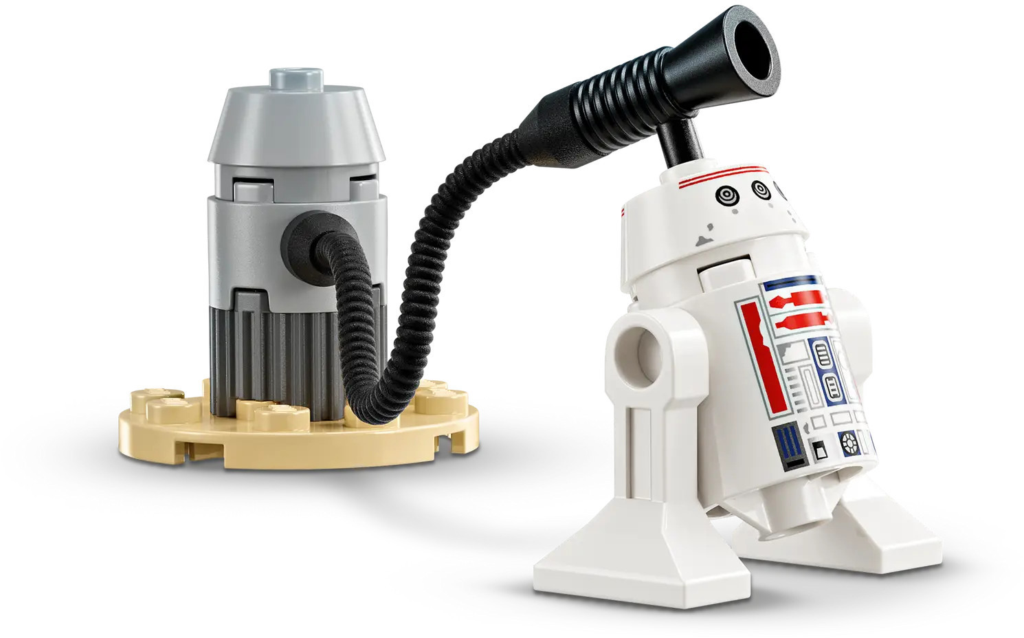 Biały robot Lego z czerwonymi i niebieskimi detalami połączony czarną rurką z szarą konstrukcją na beżowej podstawie.