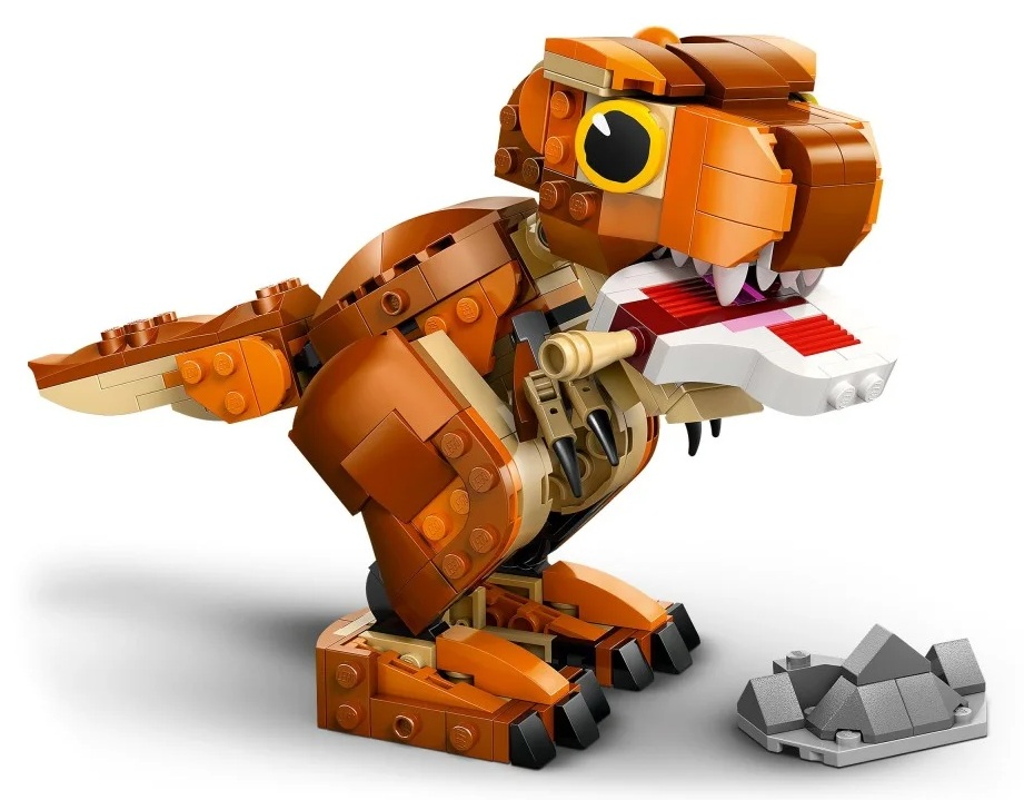 Zabawka Lego Tyrannosaurus Rex, brązowa i pomarańczowa, z otwartą paszczą pokazującą zęby i małą formacją skalną.