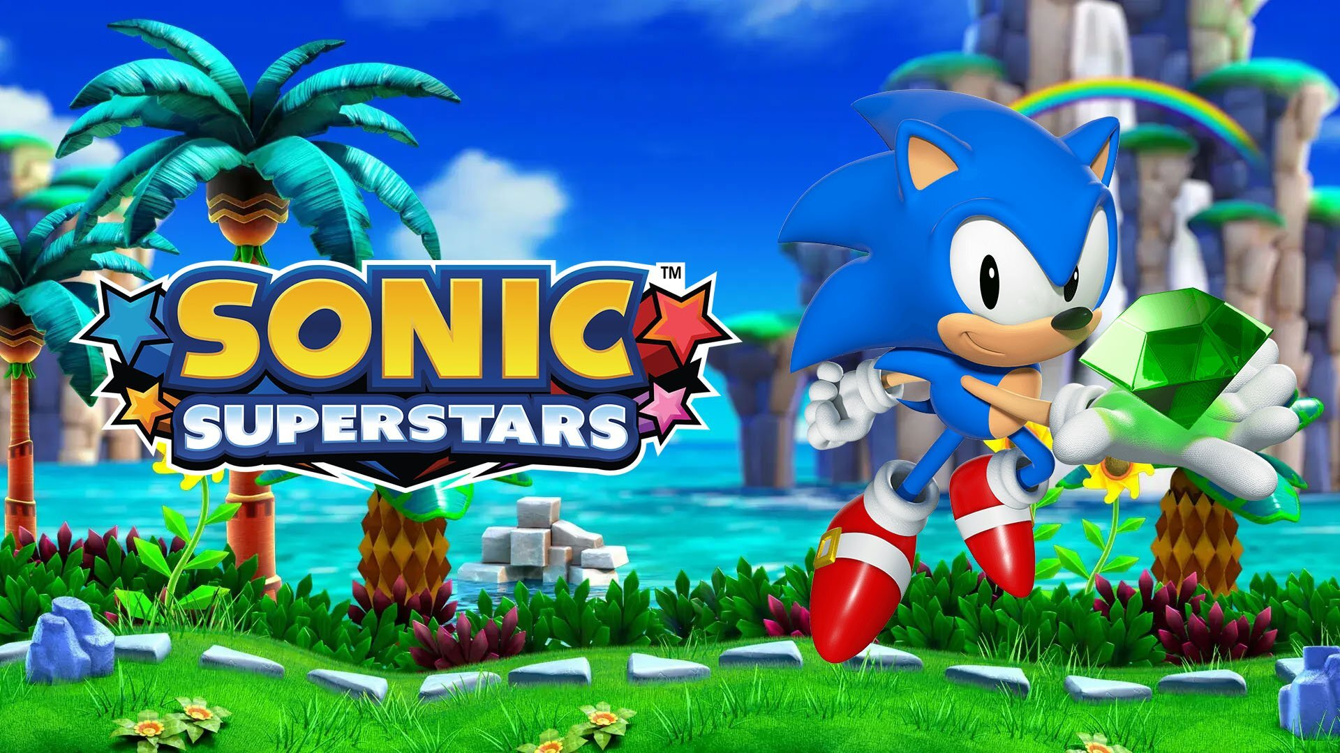 Sonic the Hedgehog yeşil bir mücevher tutuyor. 'Sonic Superstars' oyununun başlığı, palmiye ağaçları ve arka planda bir gökkuşağı ile görünür.
