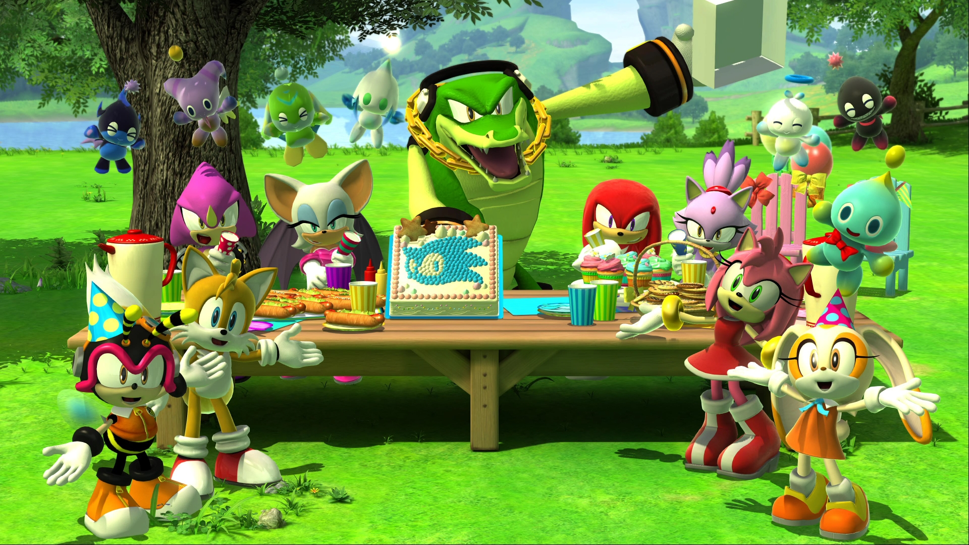 Sonic karakterleri piknikte. Timsah Vector, Tails, Amy Rose ve diğerleri, üzerinde pasta olan bir masada.