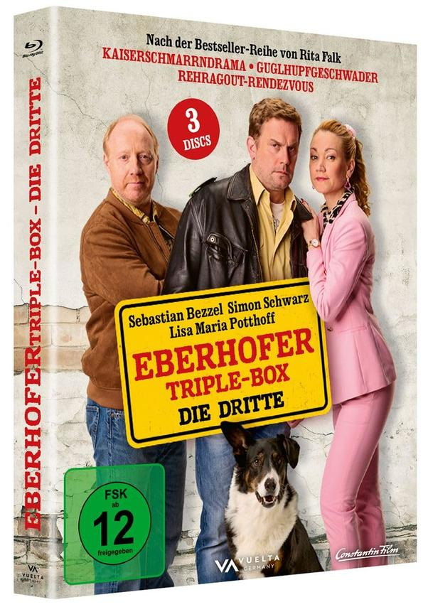DVD-Cover: Drei Personen, Hund und Titel 'Eberhofer Triple Box Die Dritte'. Enthält Schauspielernamen und eine Altersfreigabe '12'.