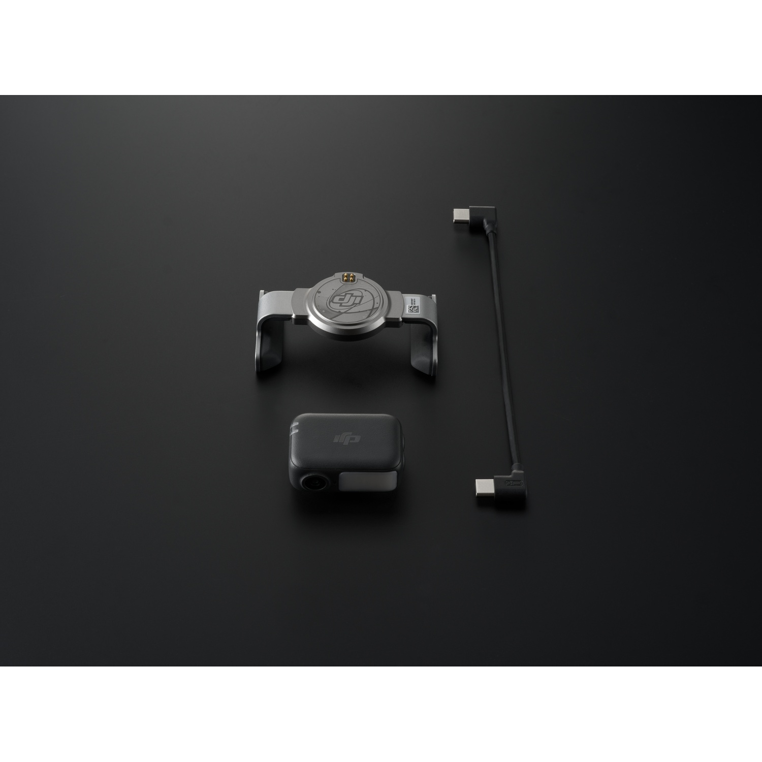 DJI product components on a black surface. Includes a metallic bracket, a black module, and a cable.