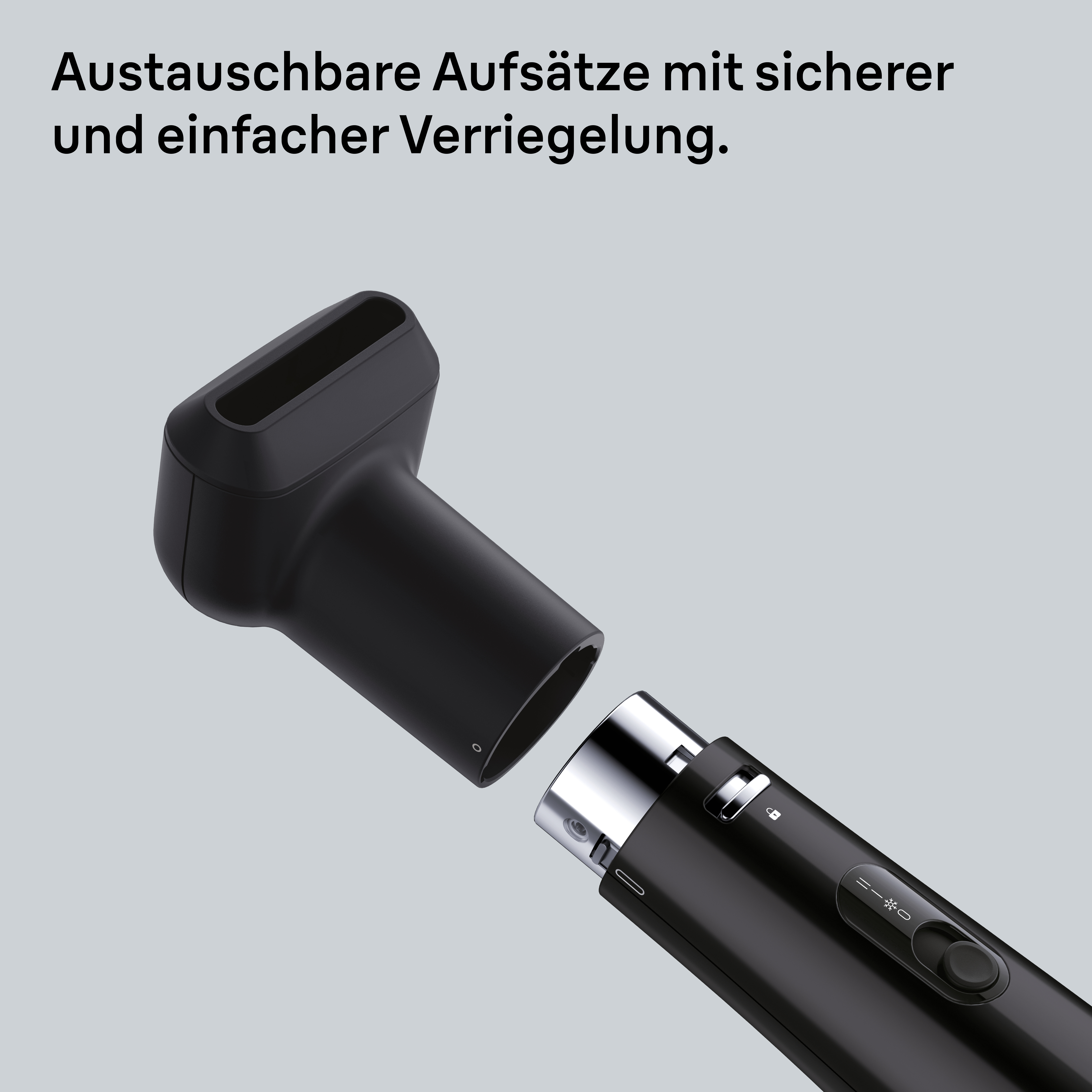 Schwarzer Haartrockner mit abnehmbarer Düse. Text oben. Grauer Hintergrund. Die Düse ist nicht befestigt.