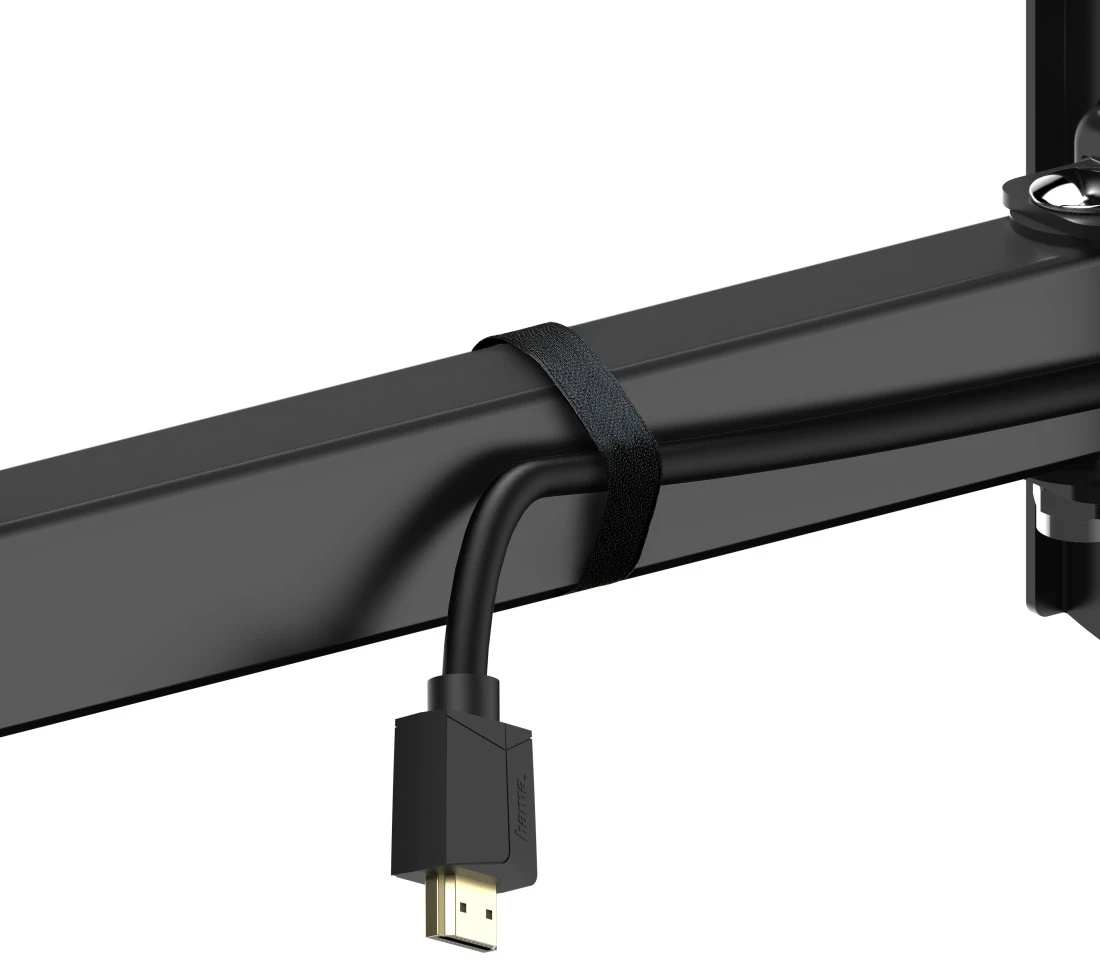 Fekete monitor kar, fekete kábellel rögzítve egy pánttal. A kábel arany színű HDMI csatlakozóval végződik.