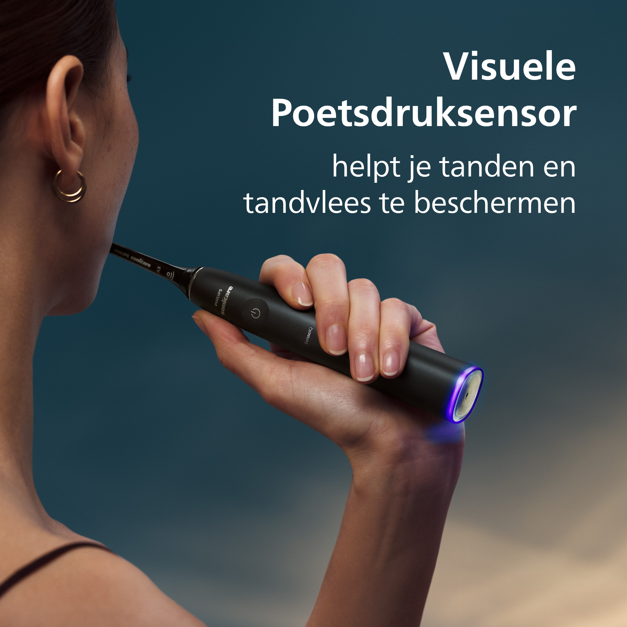 A person holds a black electric toothbrush. The text says it helps protect teeth and gums.