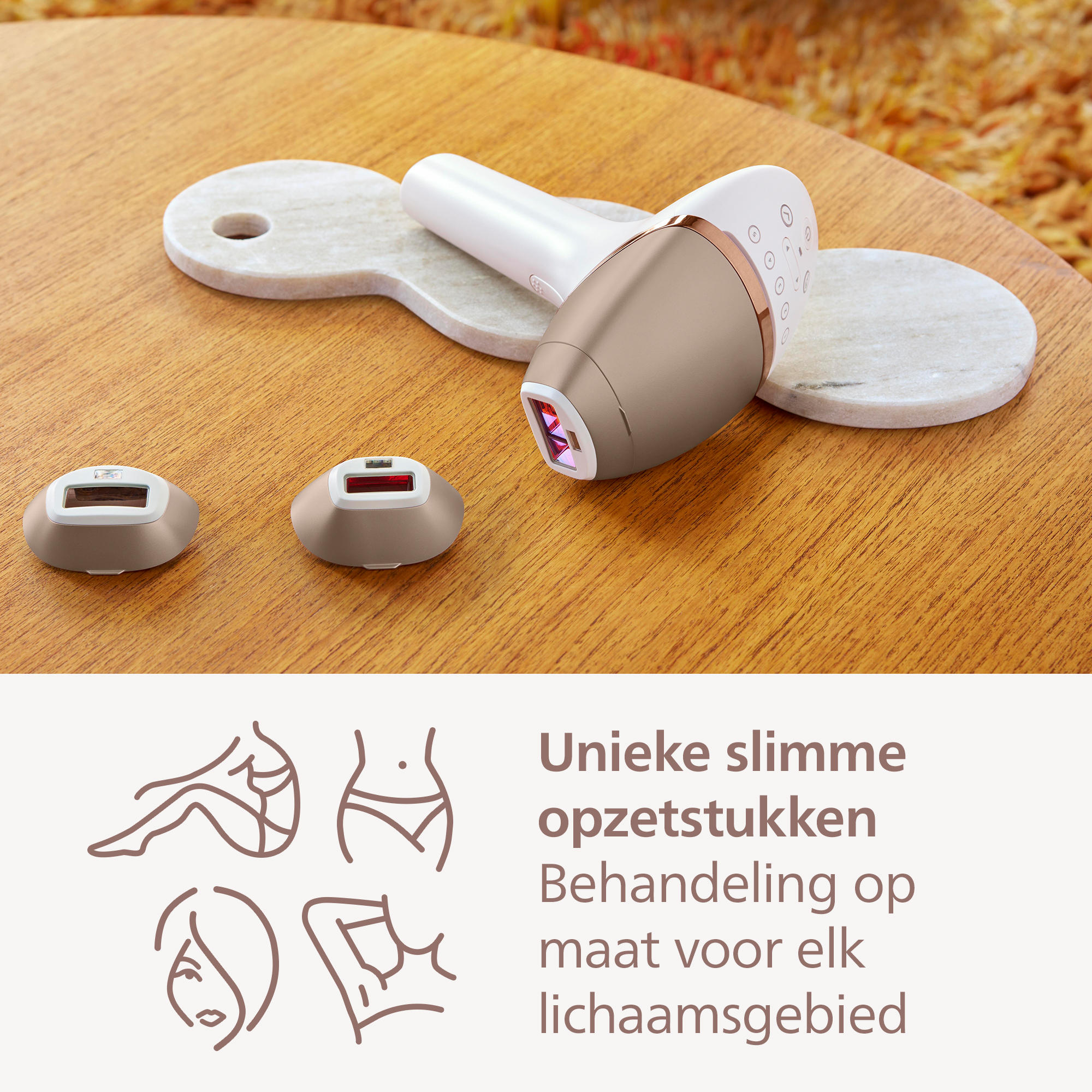 An epilator with two heads on a wooden table, with text and drawings of body parts in the background.