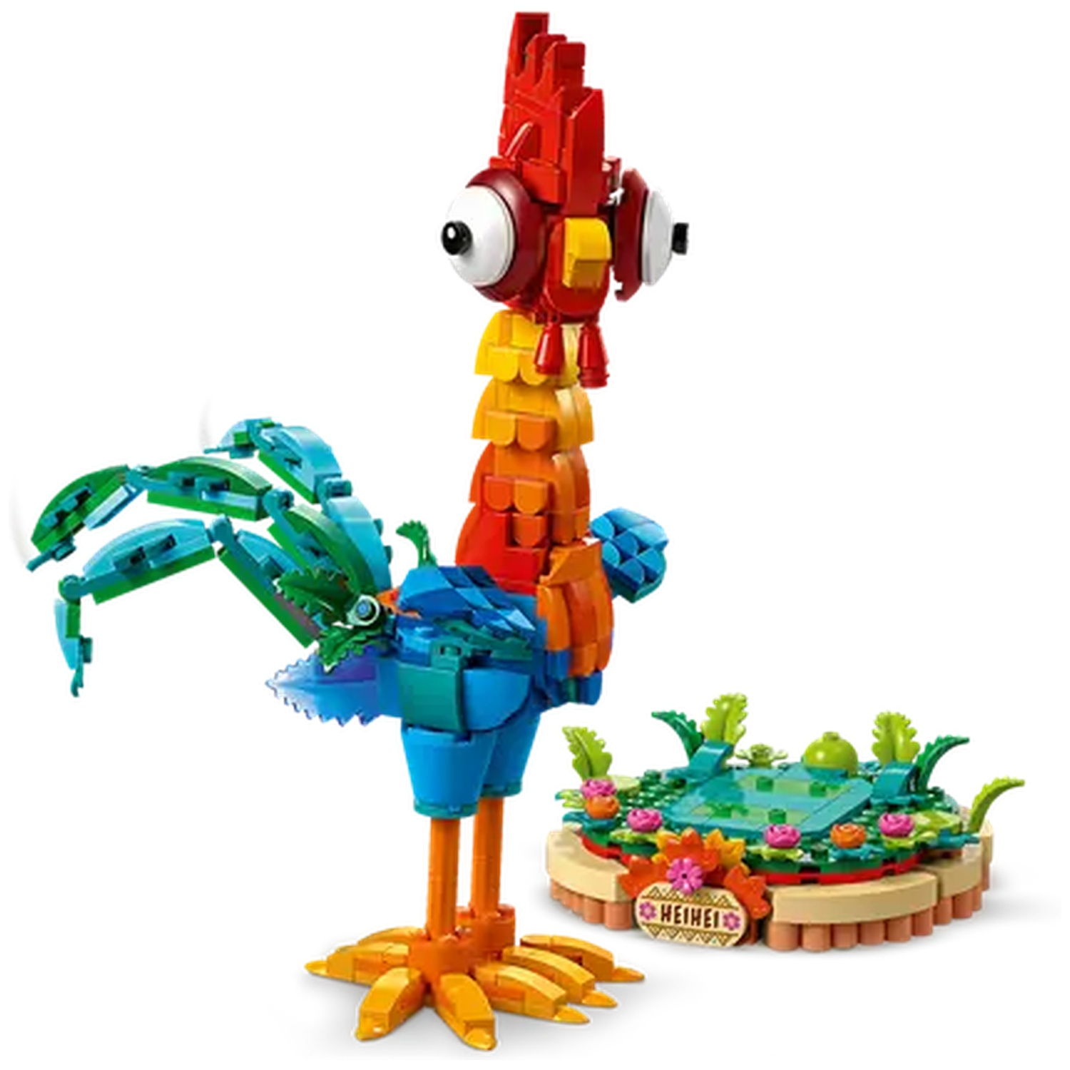 A Lego rooster with red, yellow, and blue colors. It stands next to a small, round Lego island with flowers and water.