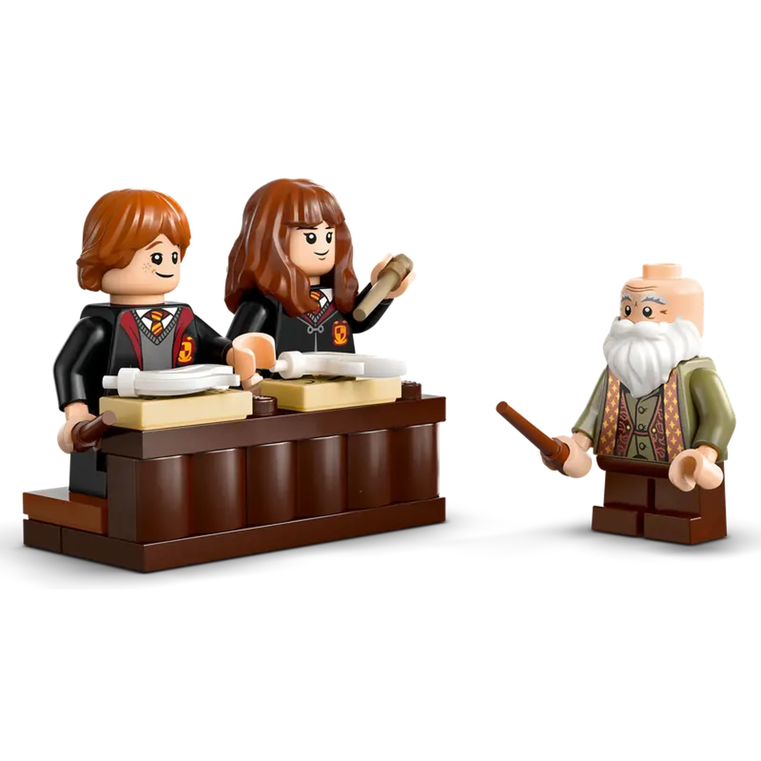 Lego set with three figures: two students at a desk, and a wizard with a wand. All on a white background.