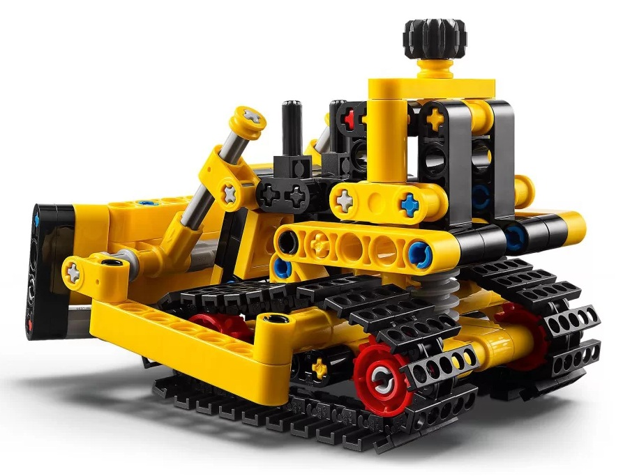 Żółto-czarny model spychacza Lego Technic. Ma czarne gąsienice, żółty korpus i czerwone koła. Tło jest białe.