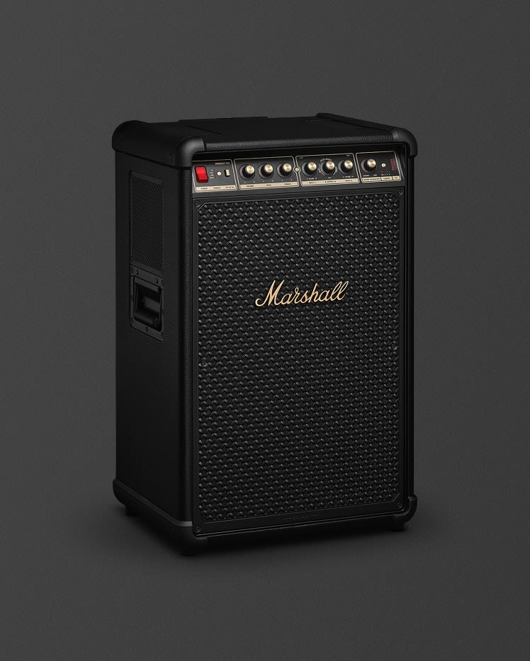 Amplificador Marshall negro, letras doradas, perillas y rejilla de altavoz. Sobre un fondo gris oscuro.