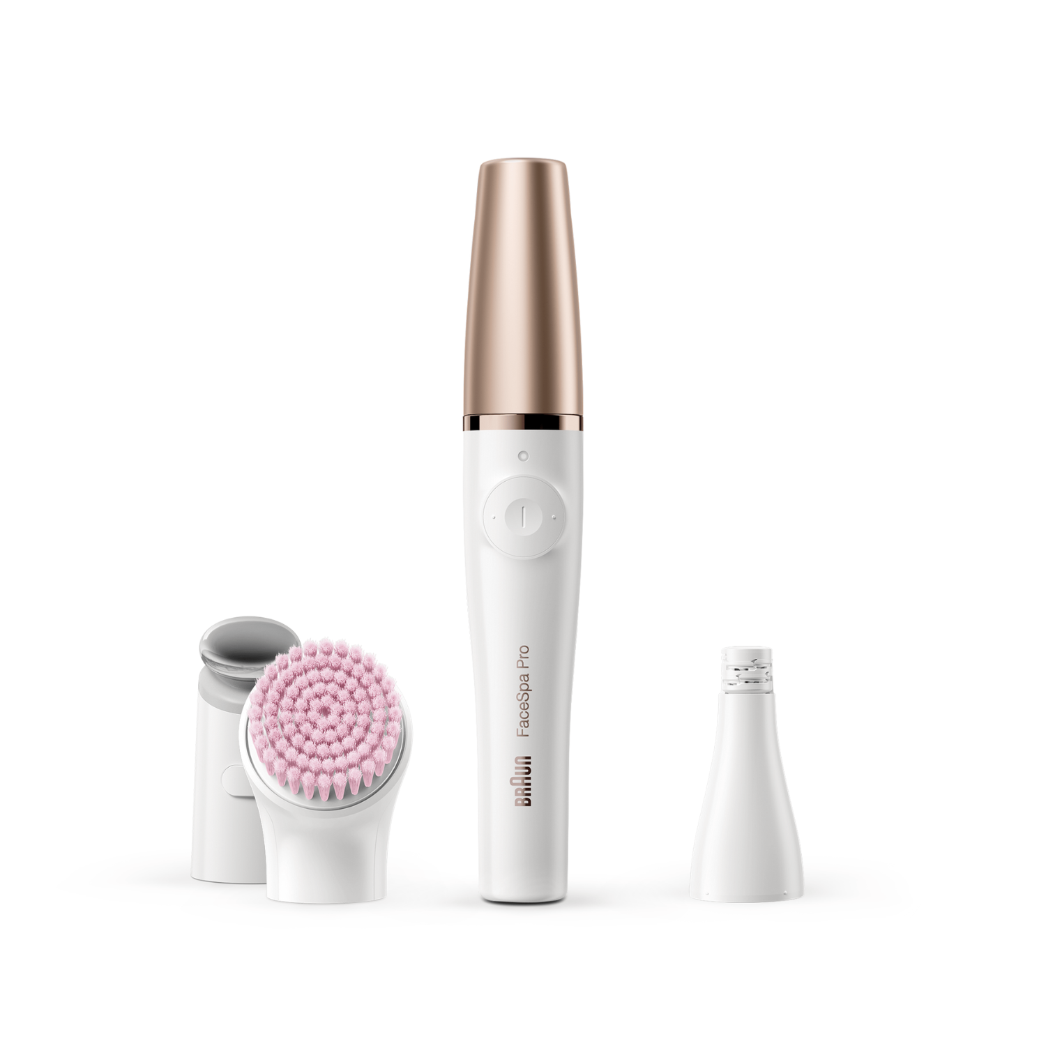 Un dispositivo Braun FaceSpa Pro con tres accesorios. El dispositivo principal es blanco con la parte superior dorada. Dos accesorios y una tapa están cerca.