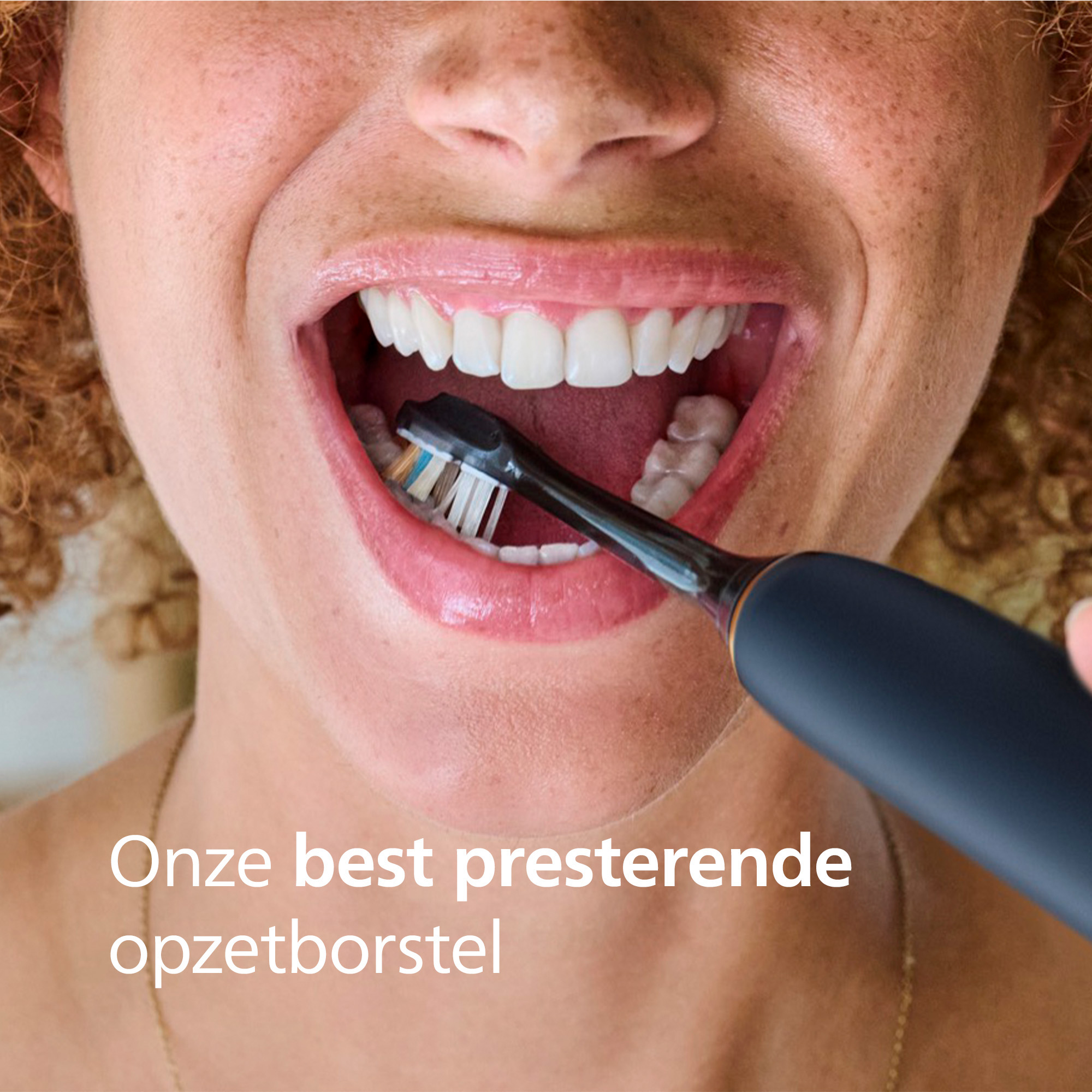 Close-up of a person brushing teeth with an electric toothbrush. The person has fair skin and open mouth with white teeth.
