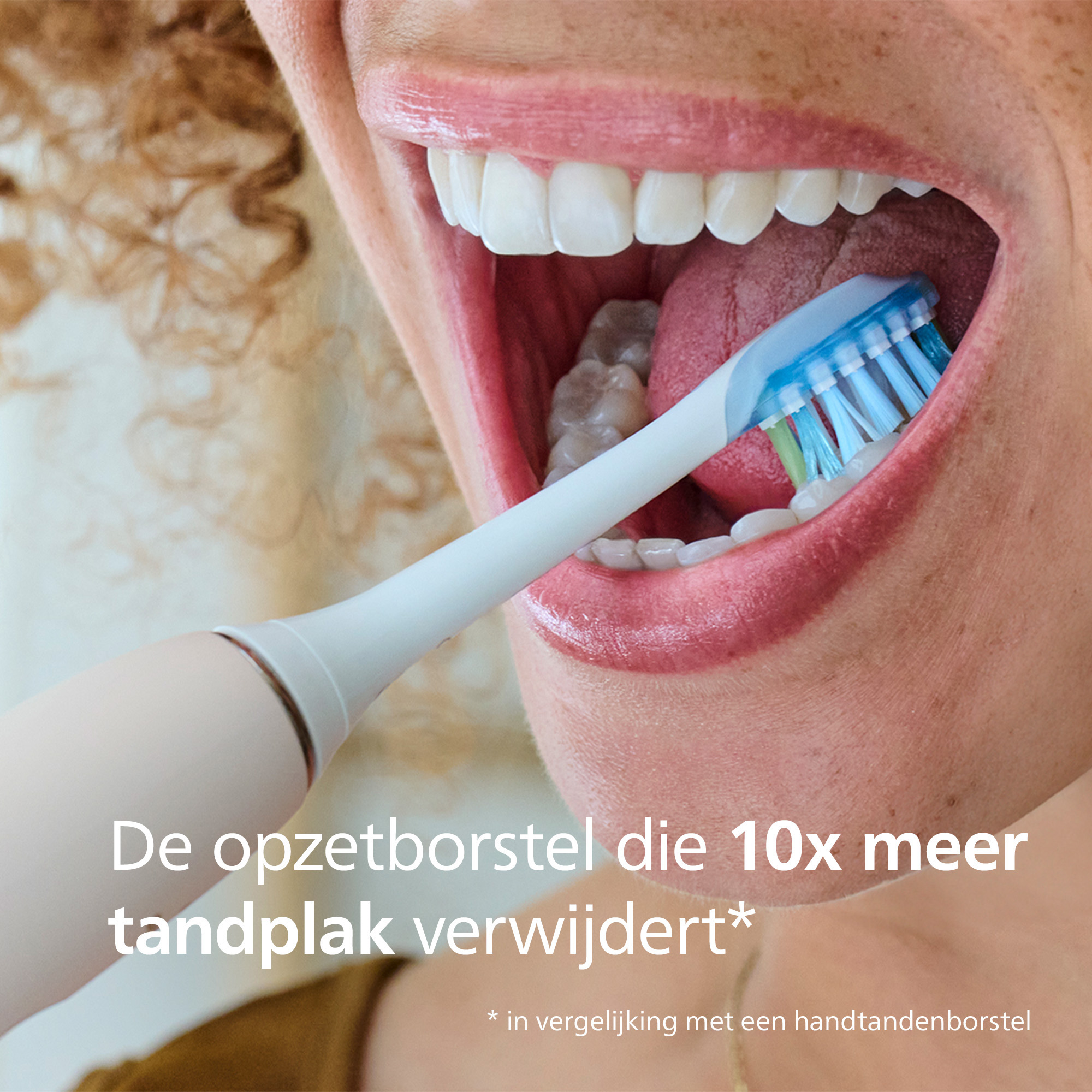 Close-up of a person brushing teeth with a white and blue electric toothbrush. Open mouth, white teeth.
