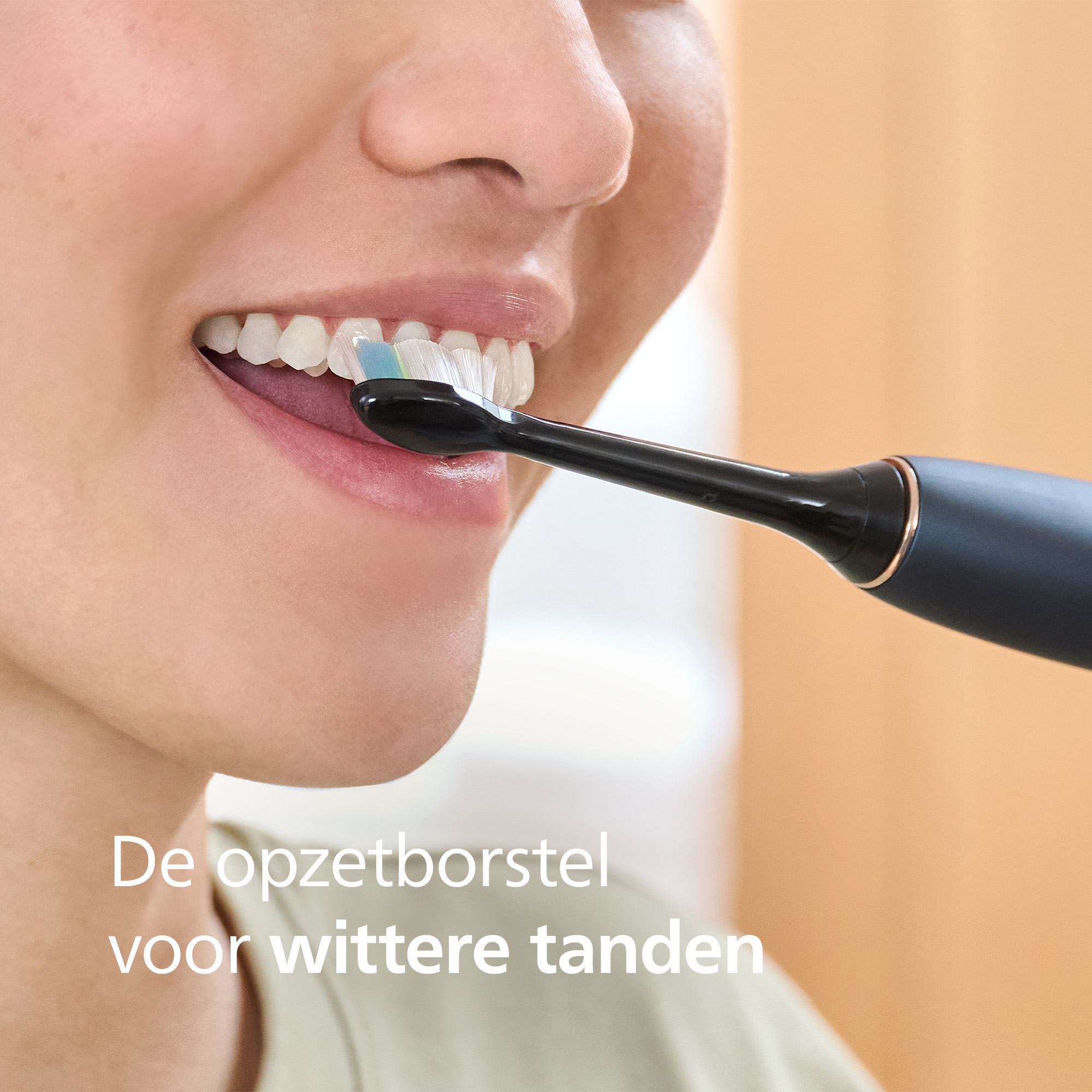 A person brushes their teeth with an electric toothbrush. The brush head is in their mouth, cleaning teeth.