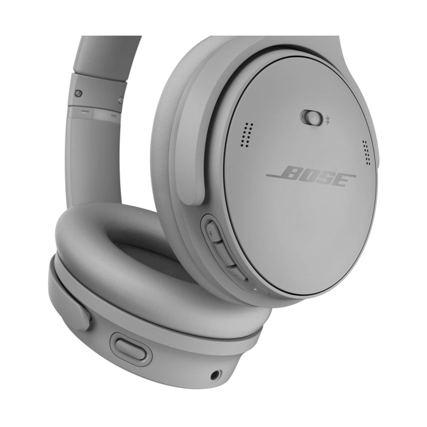 Cuffie Bose grigie. Il padiglione auricolare destro è visibile con il logo Bose e i pulsanti di controllo. Le cuffie sono su sfondo bianco.