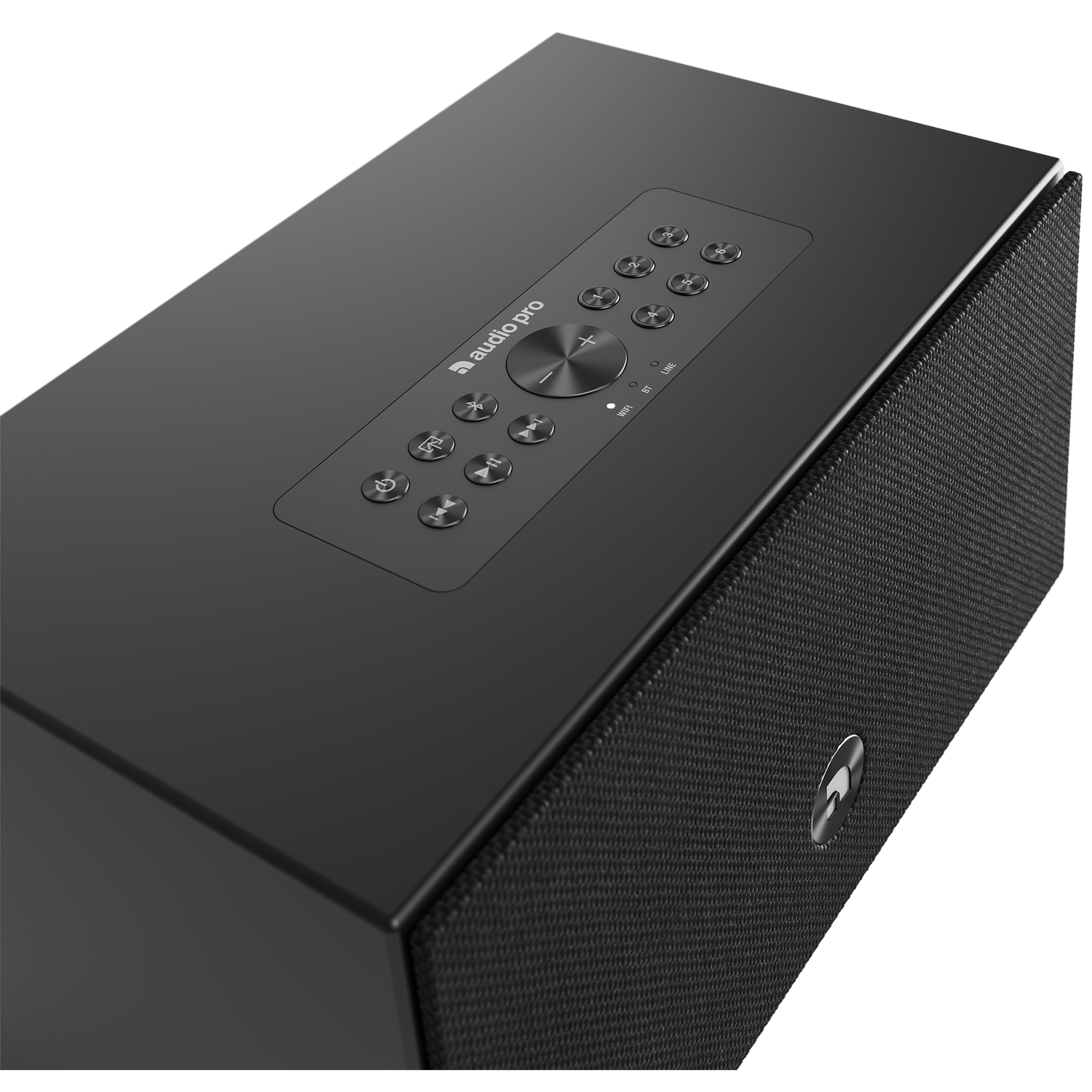 Black Audio Pro speaker. Top has buttons, a central dial, and the Audio Pro logo. The side has a mesh texture.