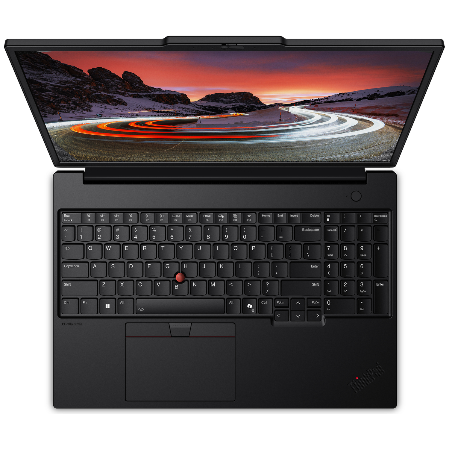 Black laptop with open display showing a road with car lights and mountains. Keyboard visible below.