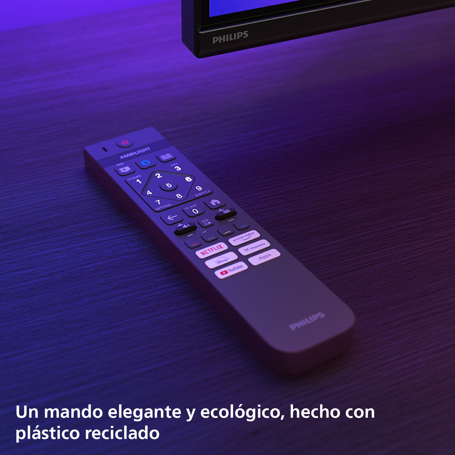 Un mando a distancia Philips sobre una mesa de madera. Tiene botones para Netflix, YouTube y otras apps.