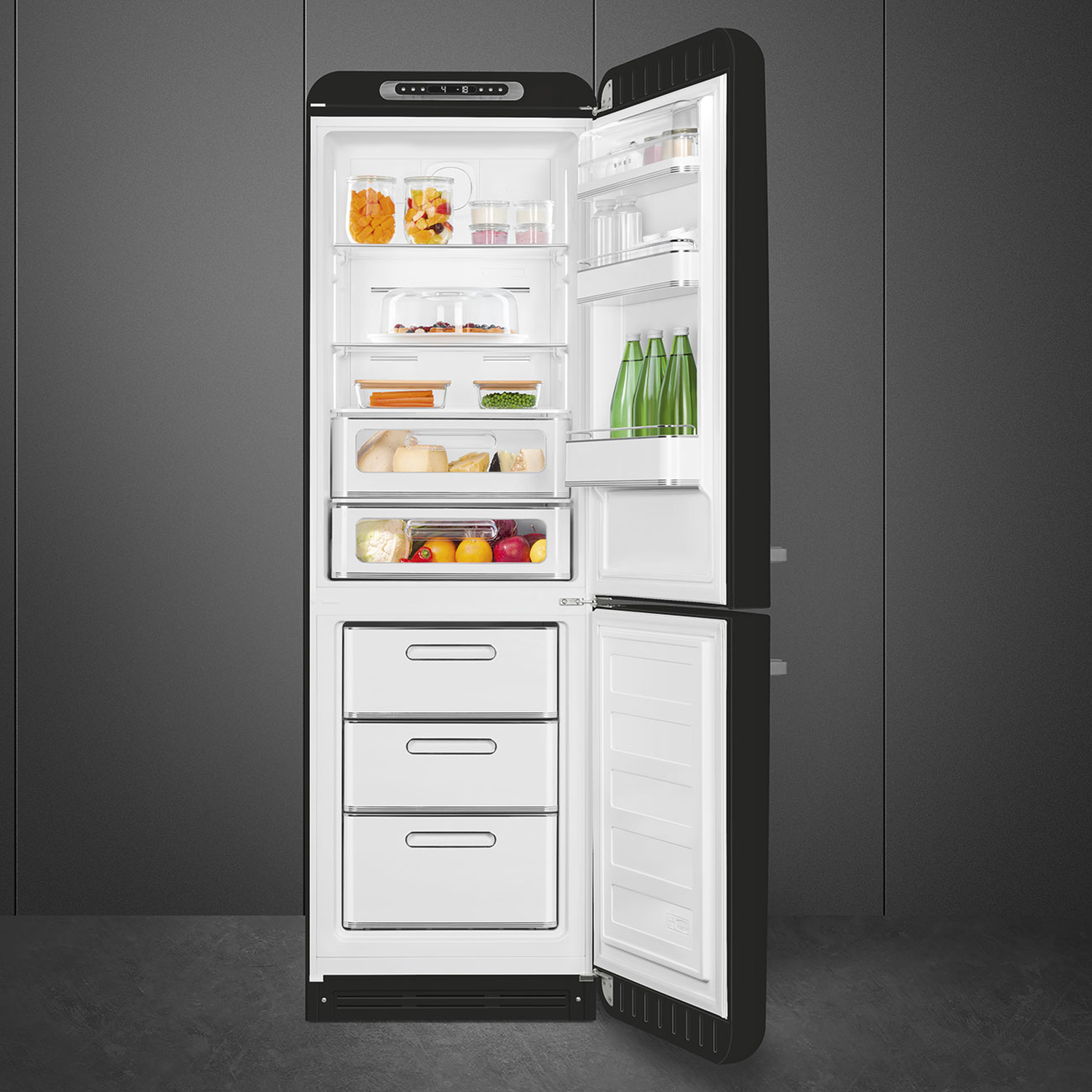 Open black refrigerator. Inside, various food items like jars of orange food, vegetables, cheese, and fruits are visible.