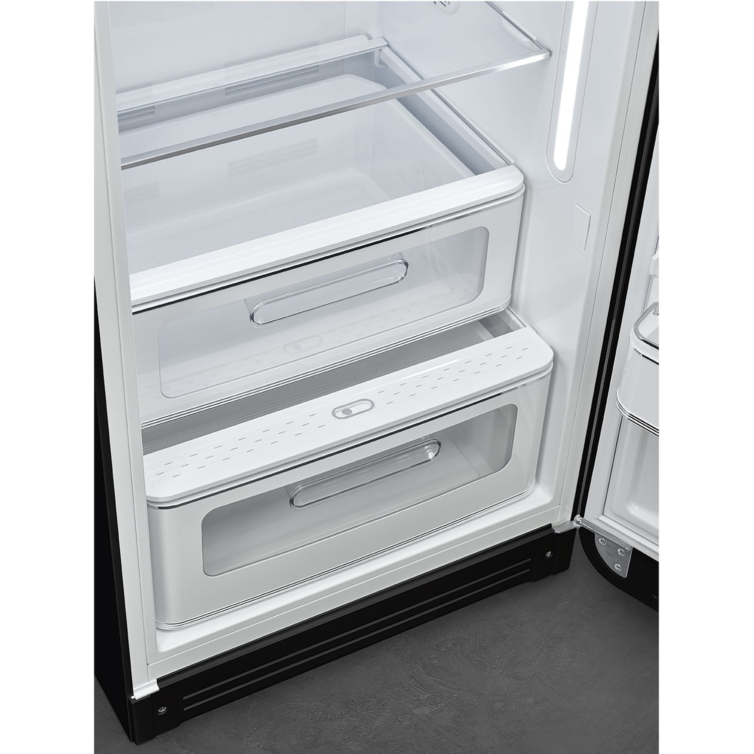 Open refrigerator interior with white drawers and shelves. Black door frame. Gray floor. Drawers are transparent.