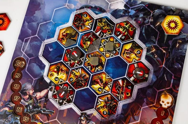 Gra planszowa z sześciokątnymi przestrzeniami. Grafika przedstawia wojowników i potwory. Widoczne są numerowane znaczniki i kostki.