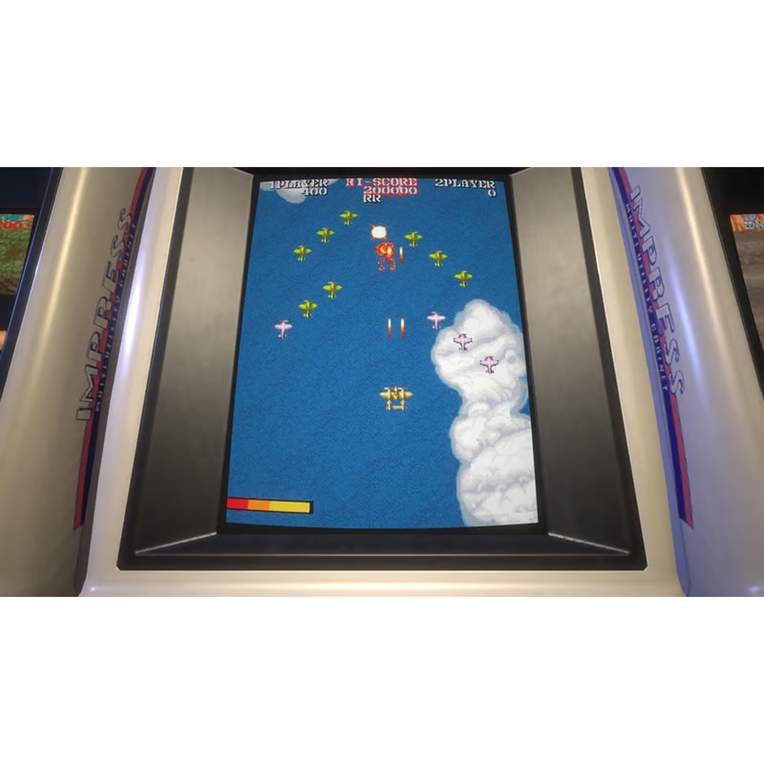 An arcade game displays a plane shooting game. Planes and missiles are visible against a blue sky. The game is inside a white cabinet.