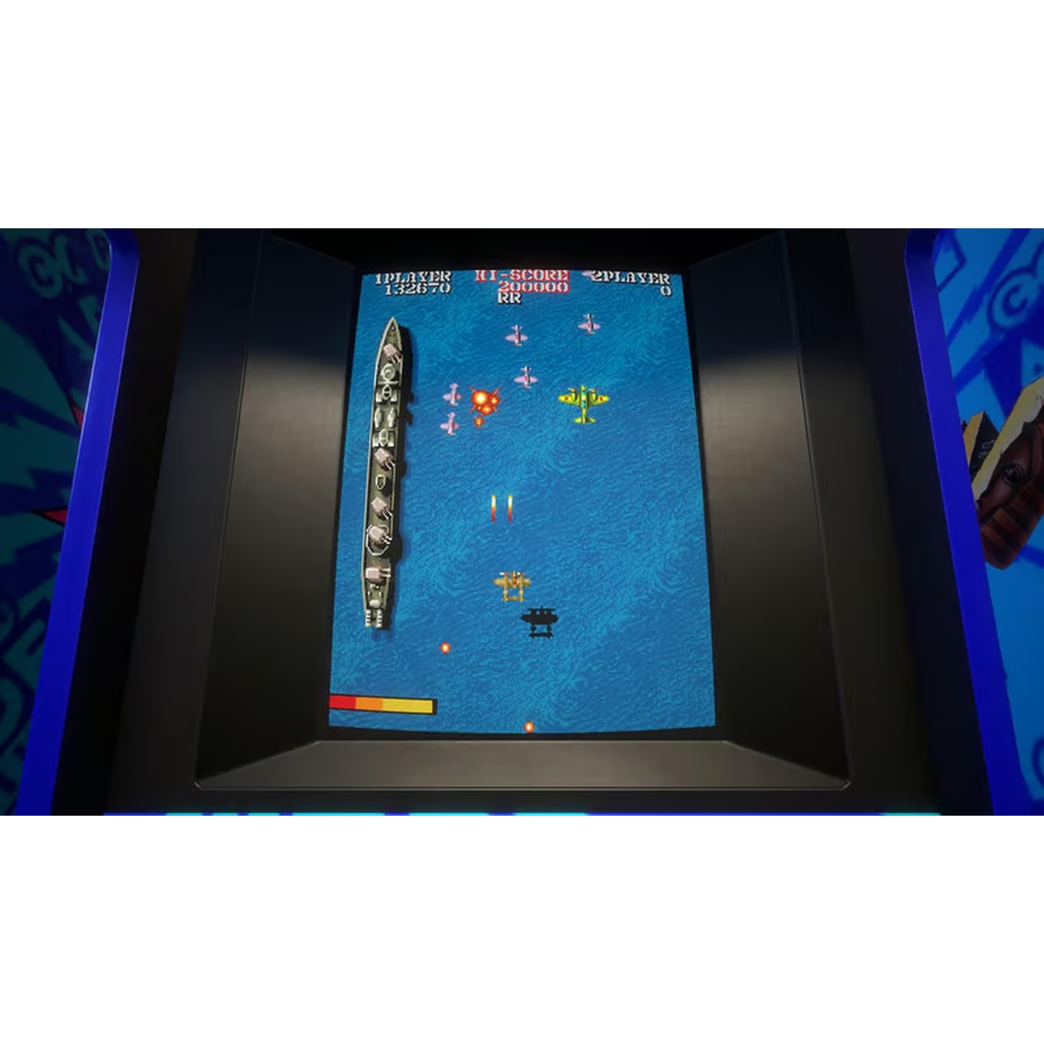 An arcade game displays a naval battle. A ship is at the top, planes are firing, and the sea is blue. The cabinet is black and blue.