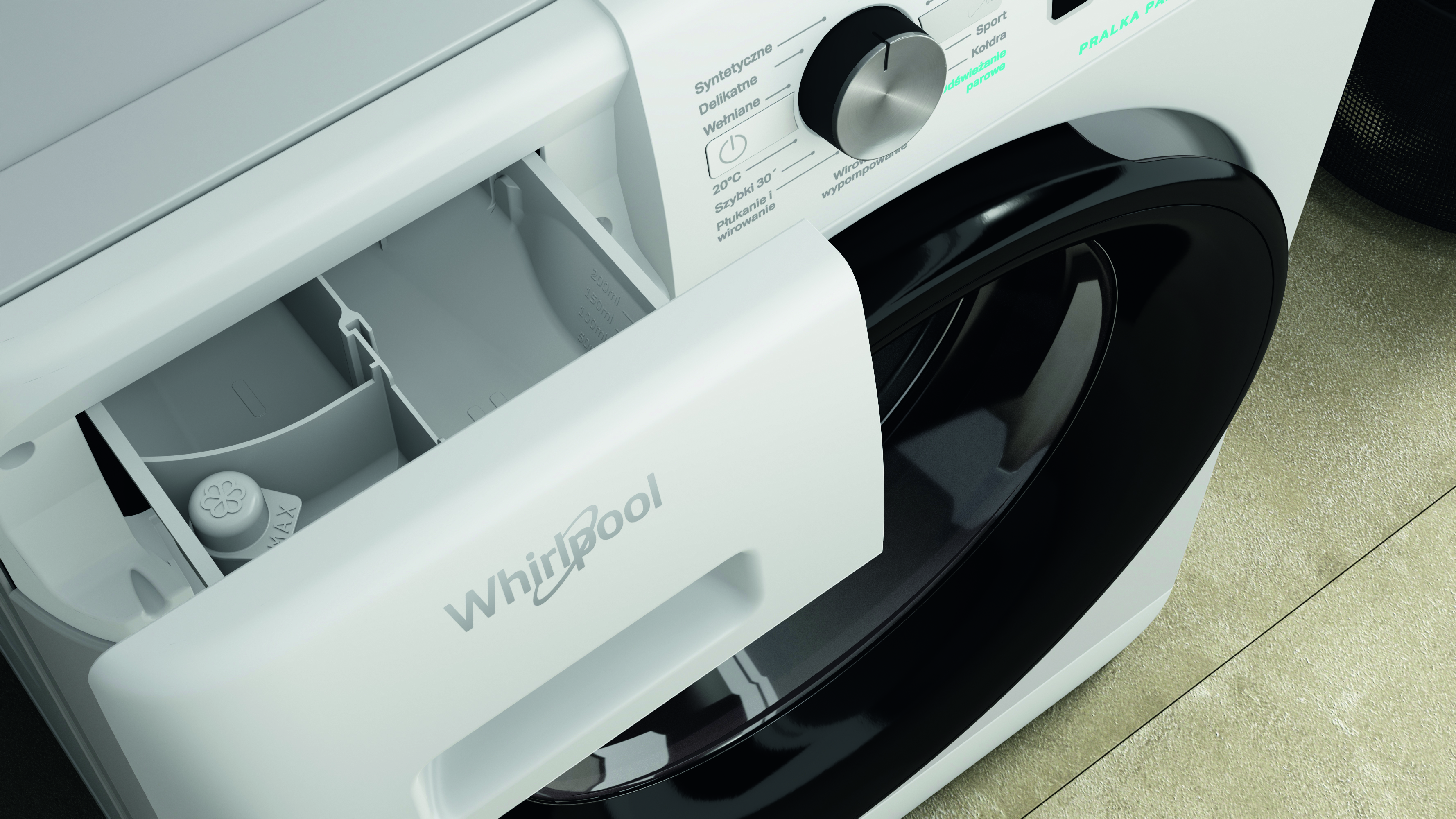 Zbliżenie białej pralki z otwartą szufladą na detergent. Widoczne czarne pokrętło i logo Whirlpool.