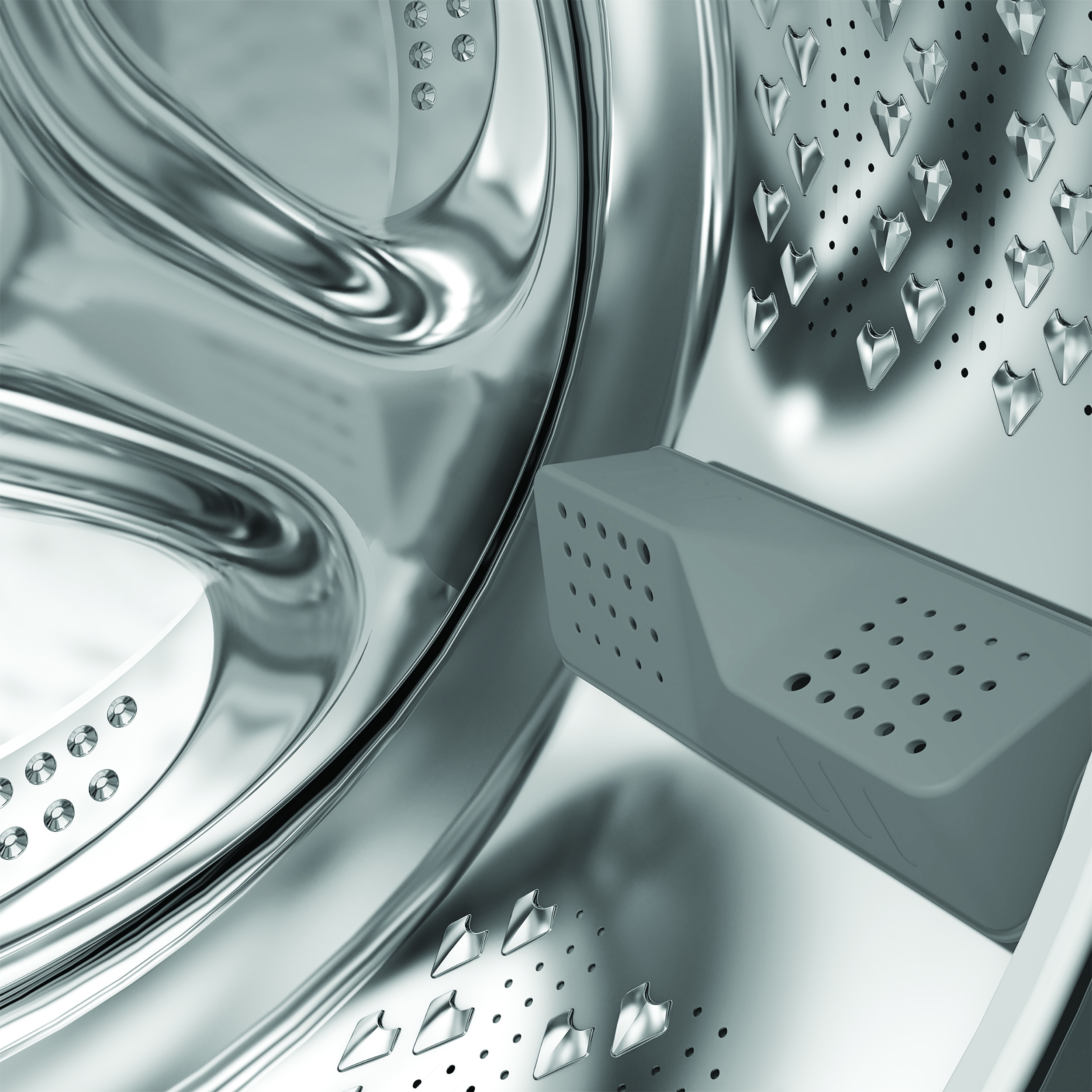 Wnętrze bębna pralki. Widoczna jest szara plastikowa część i odblaskowa stal nierdzewna.