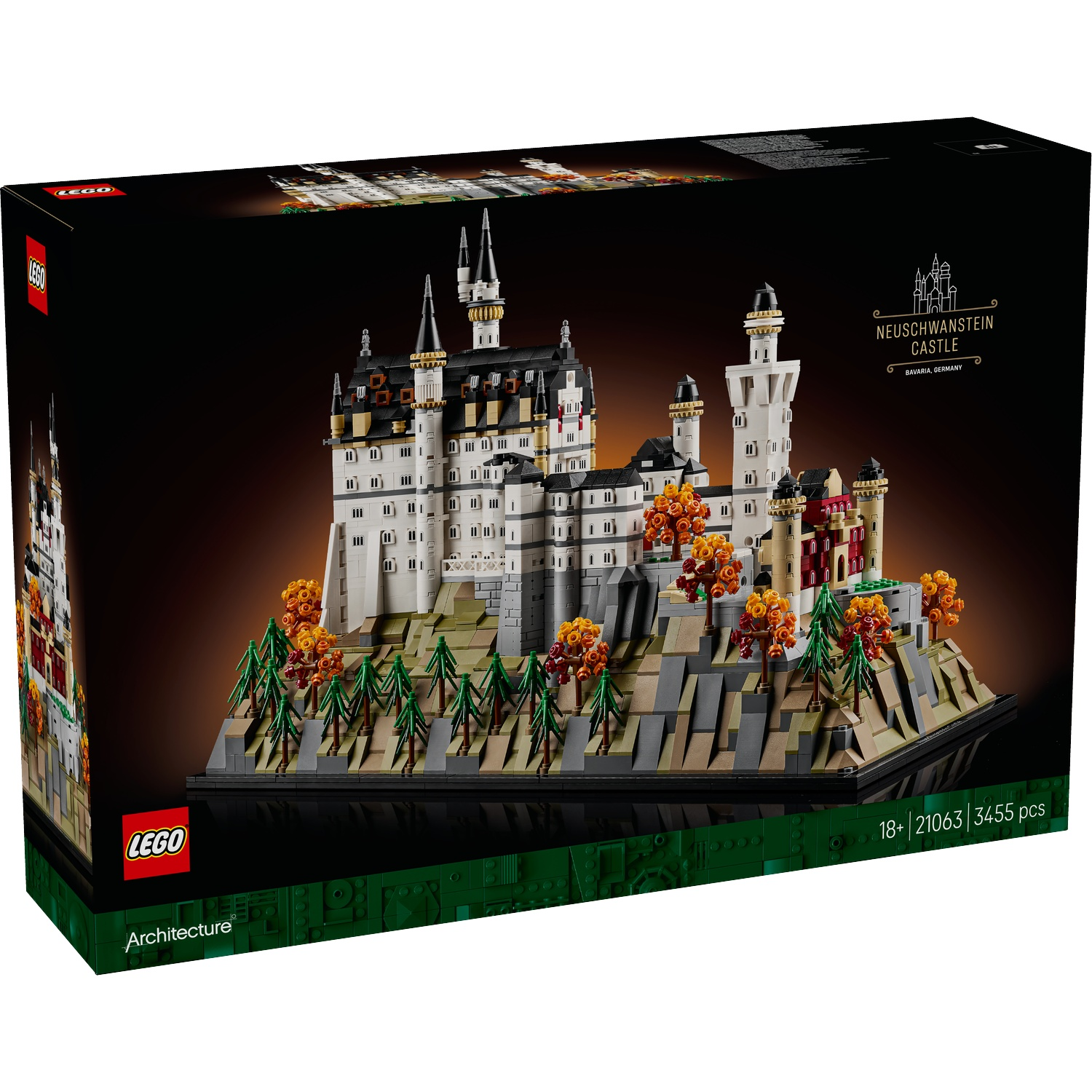 A Lego box set of Neuschwanstein Castle. The castle model sits on a rocky base with trees and is set against a black background.