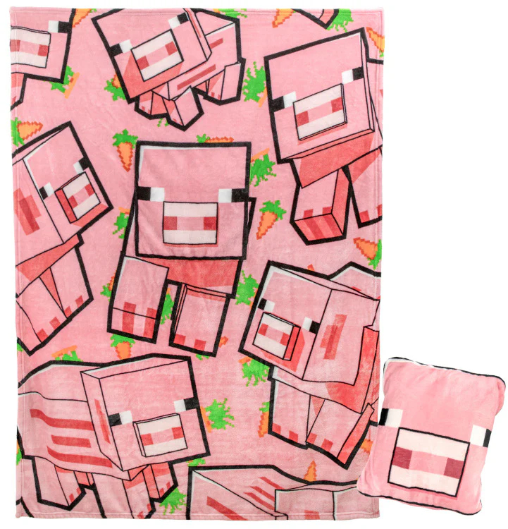 Rózsaszín takaró és párna Minecraft sertés dizájnnal. Sárgarépák és zöld pixeles bokrok vannak szétszórva a takarón. A párna jobbra van.