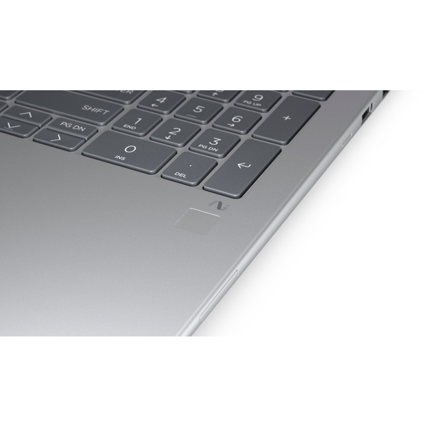 Close-up of a silver laptop keyboard. Keys are dark gray with white lettering. Numbers, arrows, and function keys are visible.