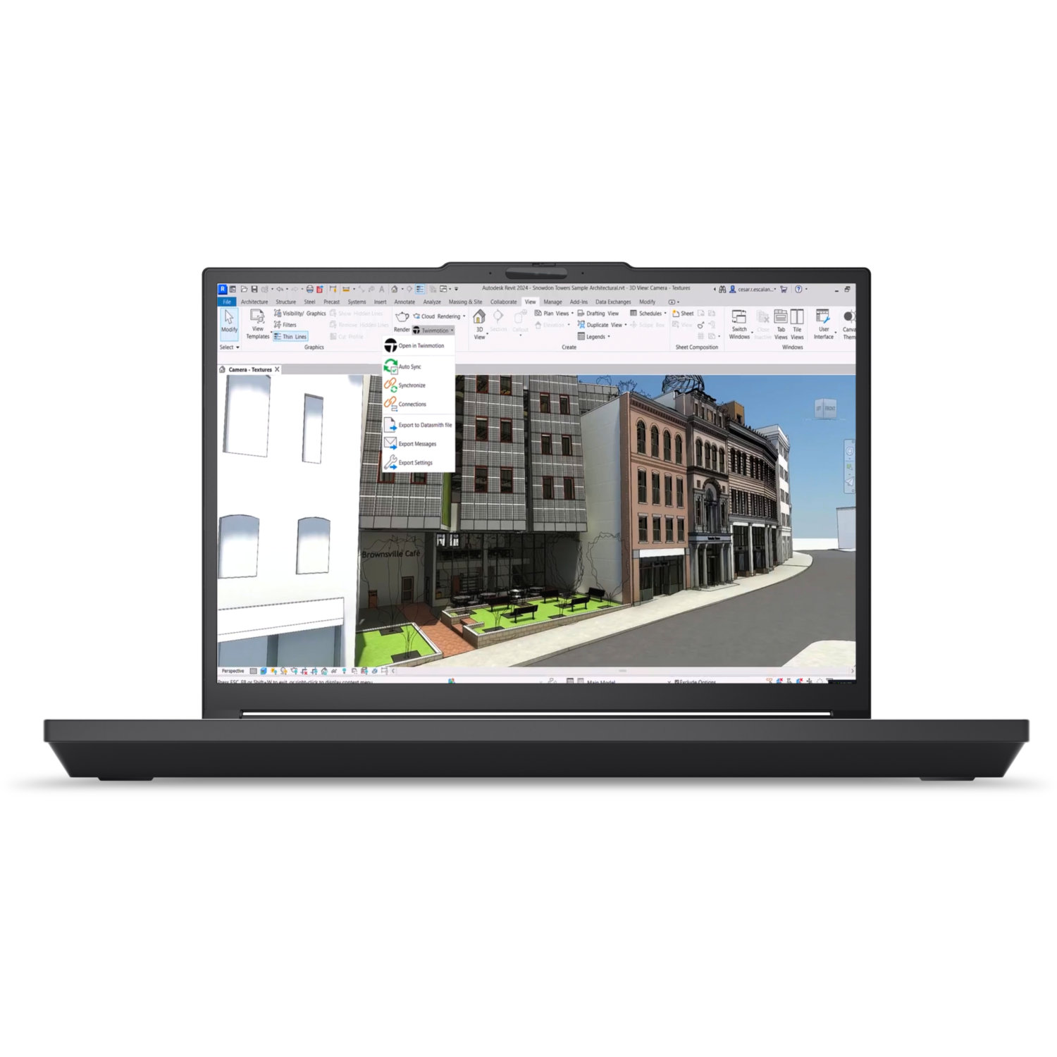 A laptop displays a 3D architectural model. The screen shows buildings, a street, and a cafe. The laptop is black.