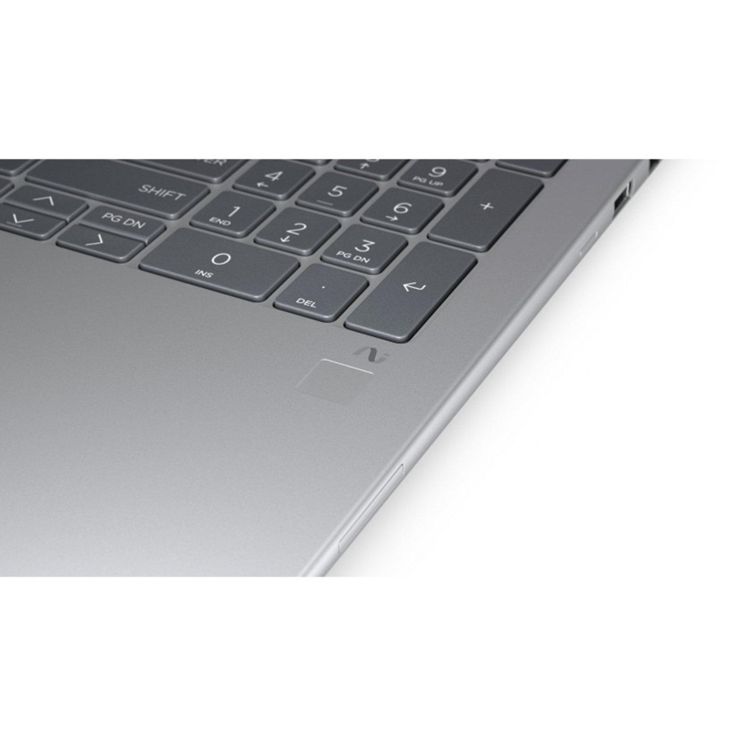 Close-up of a laptop keyboard. Gray keys with white lettering are visible. The laptop's silver body is also partially visible.