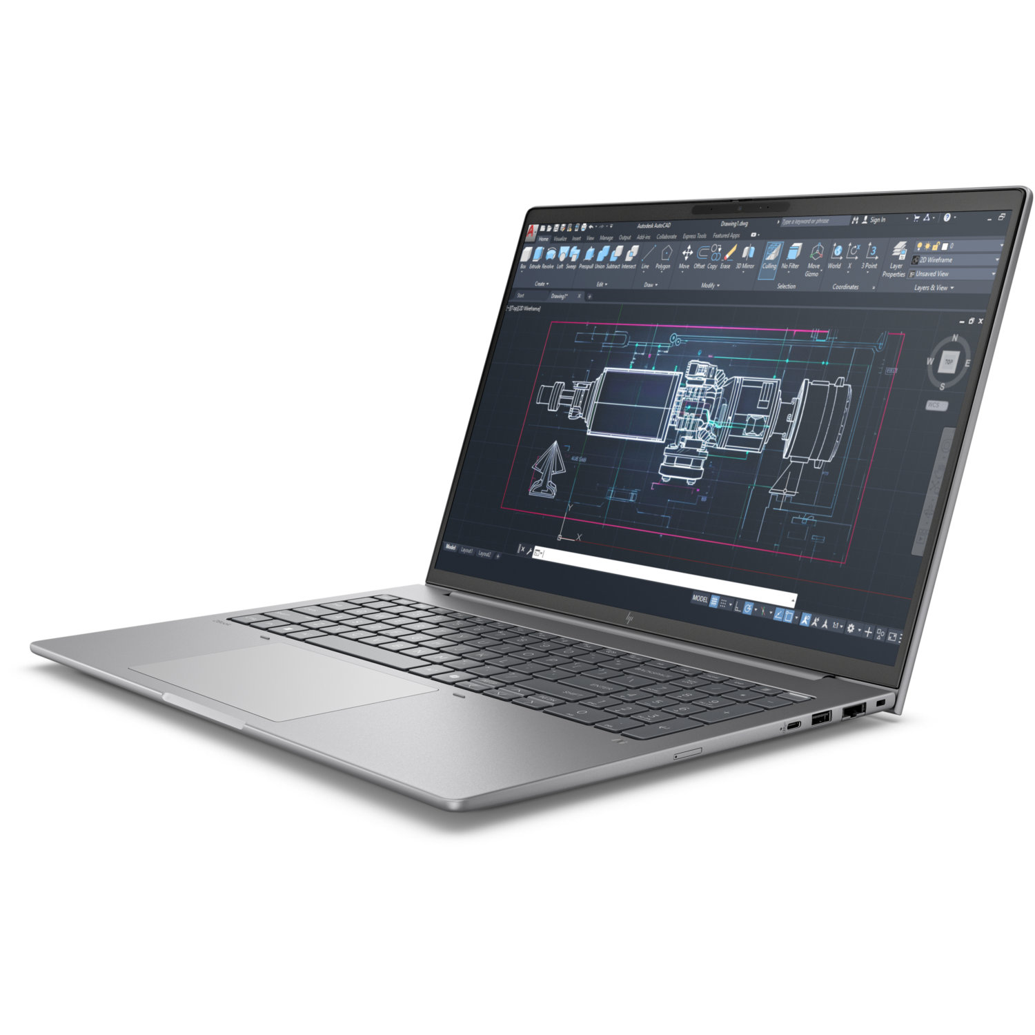 Un ordinateur portable argenté affiche un dessin AutoCAD sur un écran sombre. L'ordinateur est incliné, montrant le clavier et le pavé tactile.