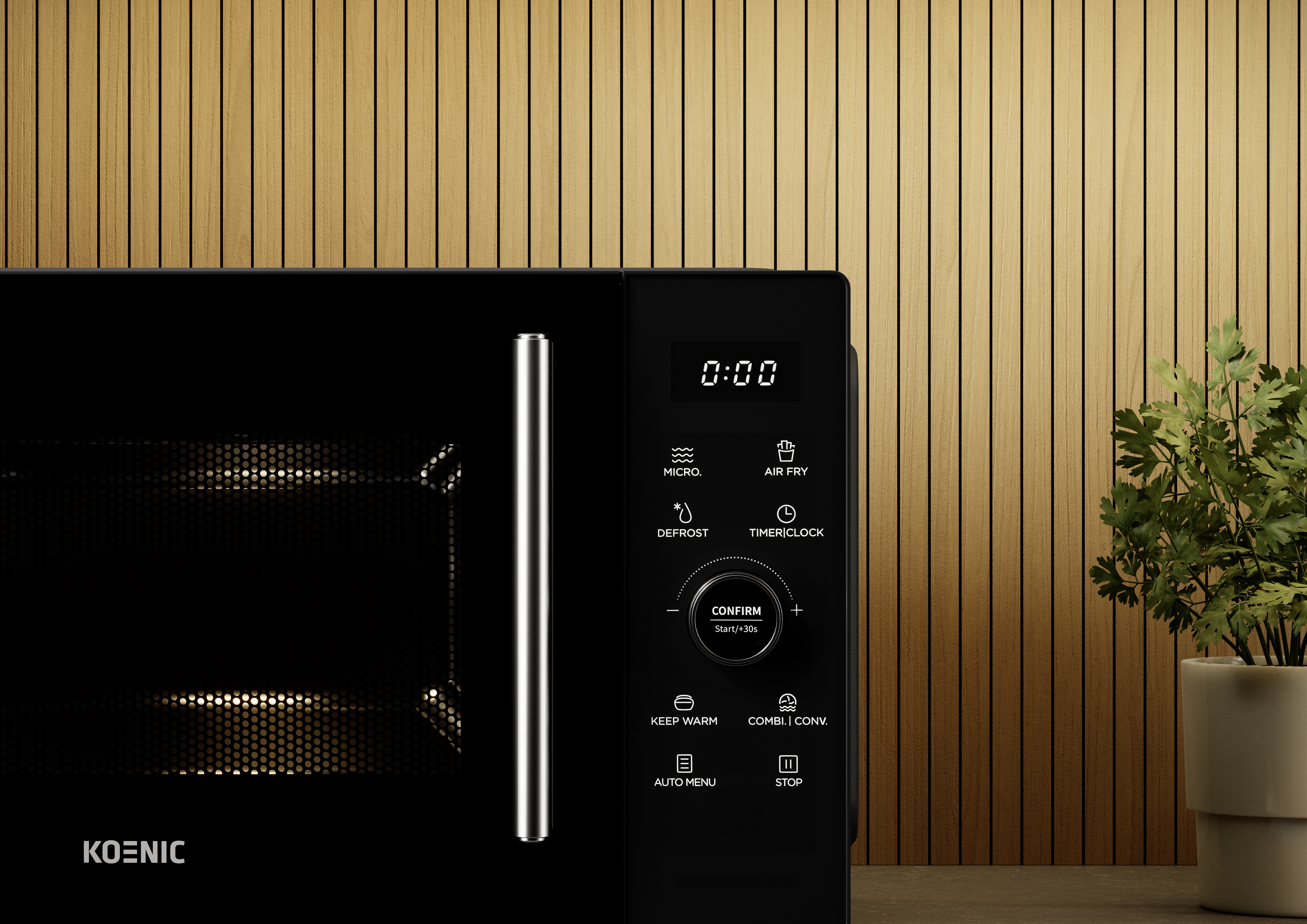 Czarna kuchenka mikrofalowa z cyfrowym wyświetlaczem, przyciskami i srebrnym uchwytem. Tło z drewnianych paneli z rośliną w doniczce po prawej.