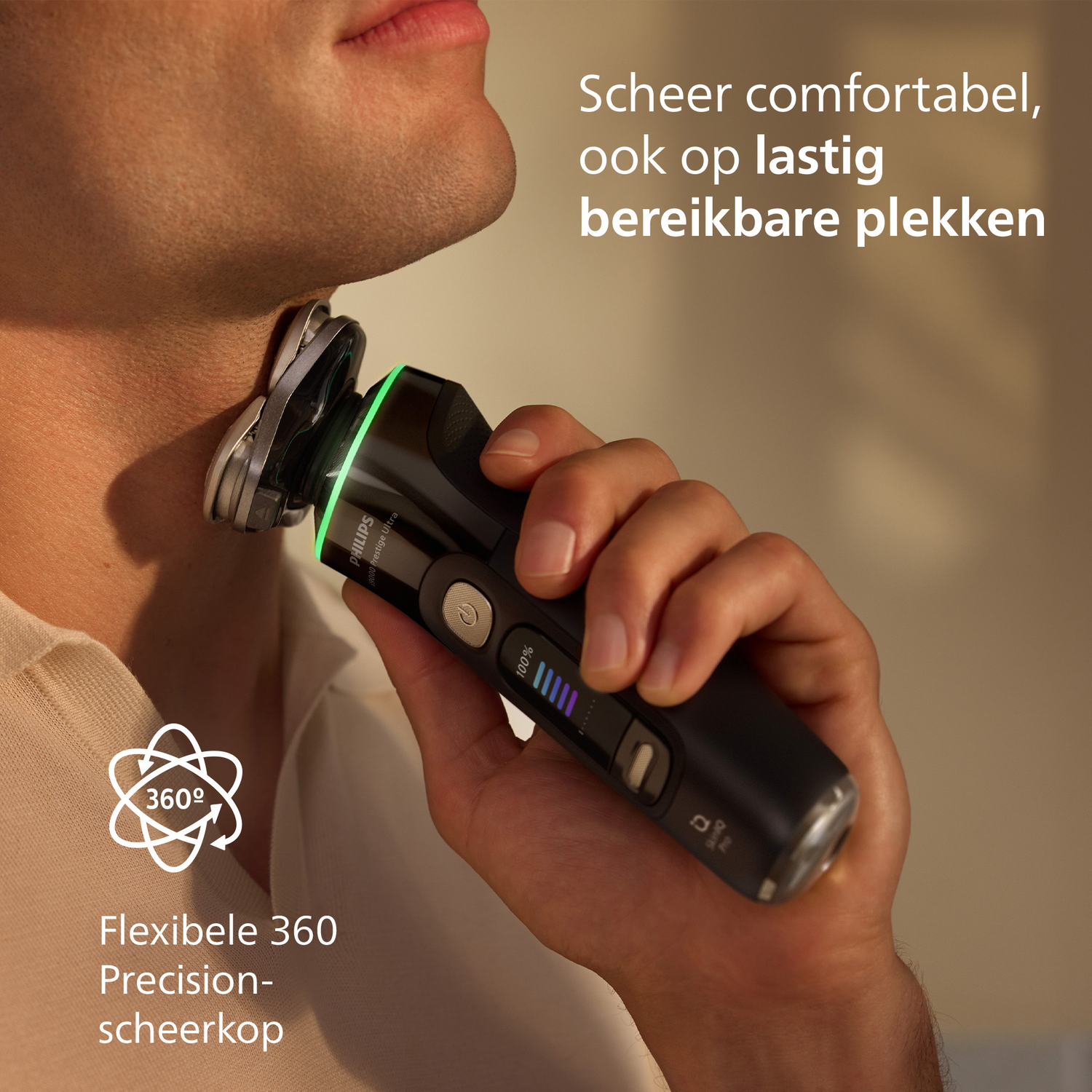 A man shaves his neck with a black Philips shaver. The shaver has a green light and a 360-degree head. Text says 'Comfortable shave'.
