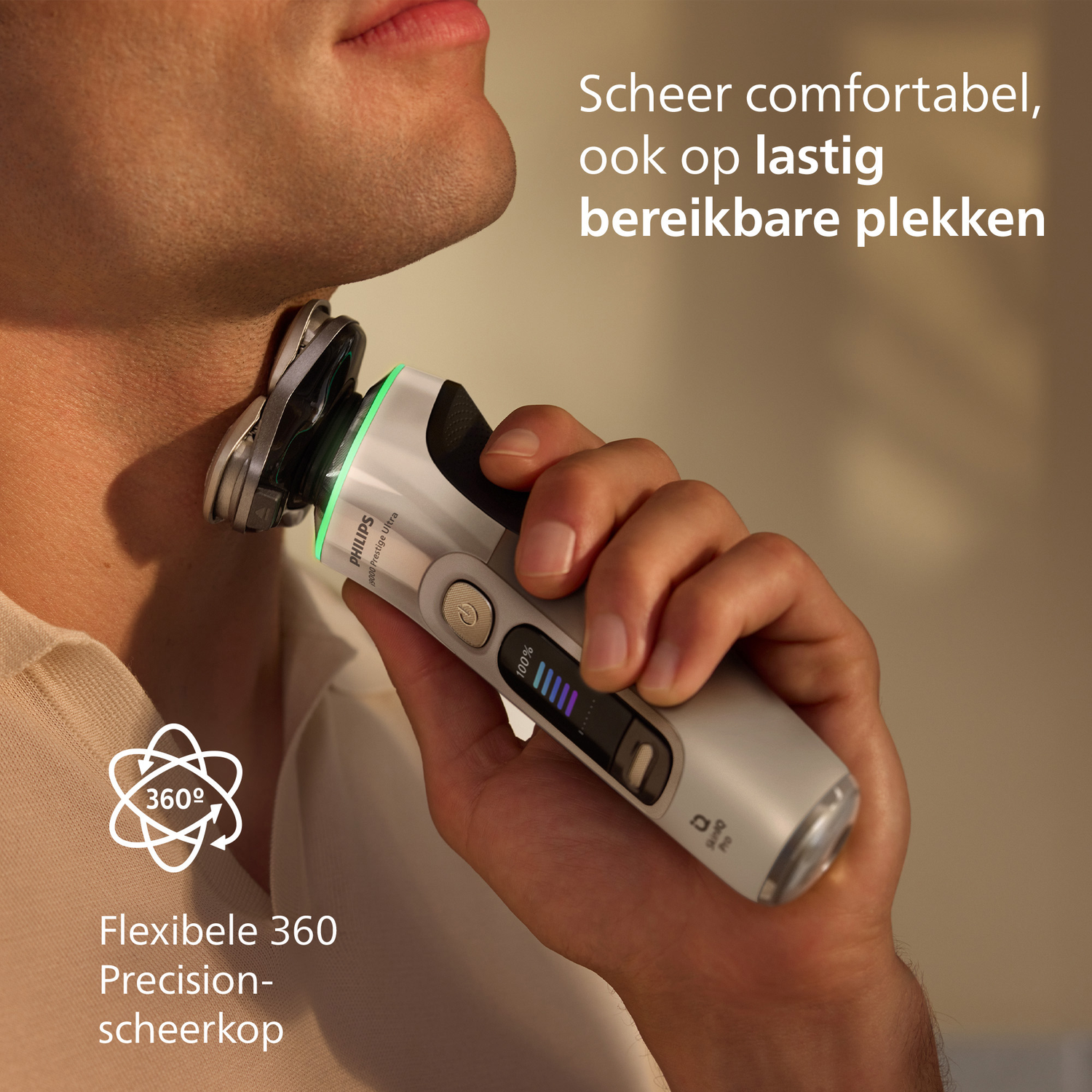 A person shaves their neck with a Philips shaver. The shaver is gray and black with a green light. Text says: comfortable shave.