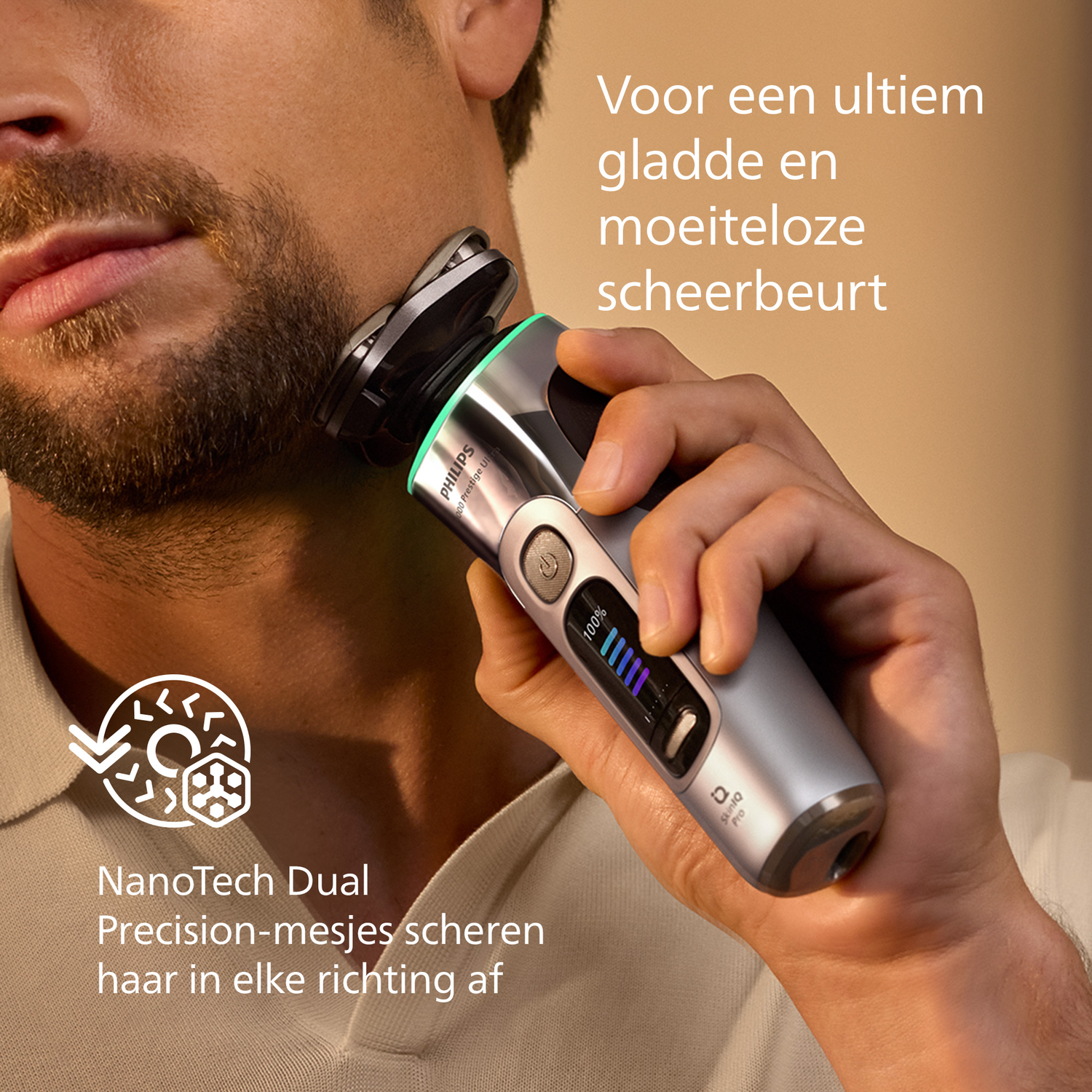 Een man scheert zijn baard met een Philips scheerapparaat. Het scheerapparaat is grijs en zwart. Tekst: NanoTech Dual, precisie messen scheren haar af.