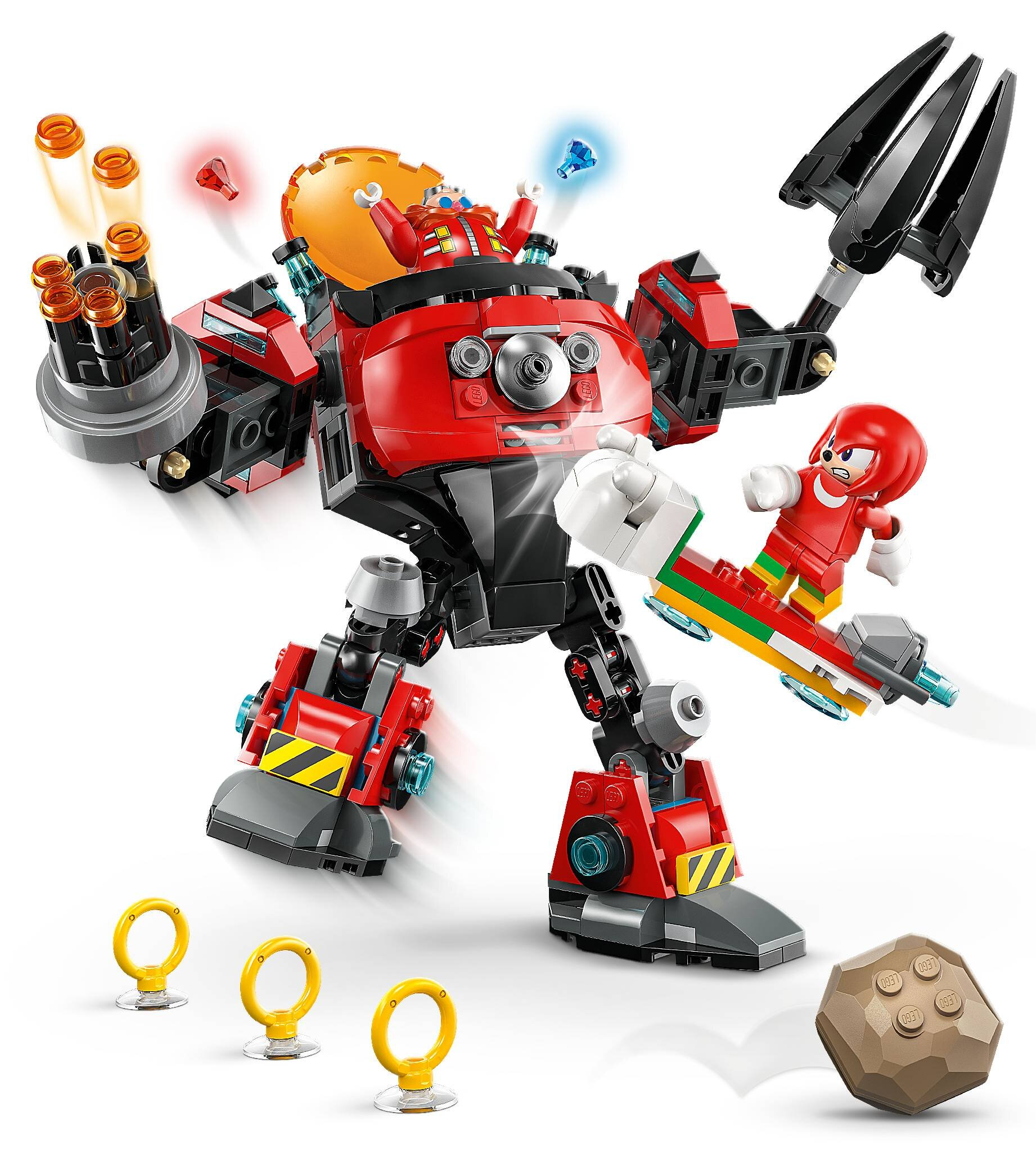 Zestaw Lego z czerwonym robotem z Dr. Eggmanem, Knucklesem na hoverboardzie, pierścieniami i brązową skałą na białym tle.