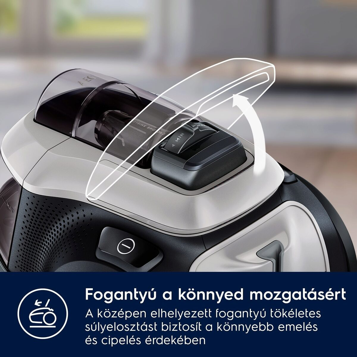 A porszívó közeli képe. Átlátszó teteje, vezérlőpanelje és fogantyúja van. A fogantyú megkönnyíti az emelést és a szállítást.