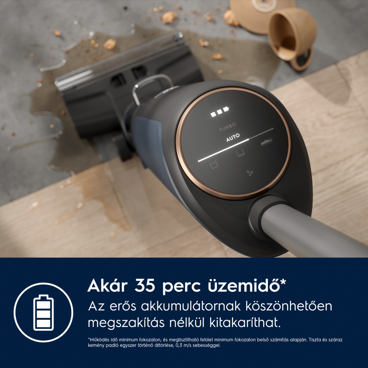 Egy fekete-bronz porszívó közeli képe digitális kijelzővel. A háttérben kiöml ött folyadék és egy csésze látható.