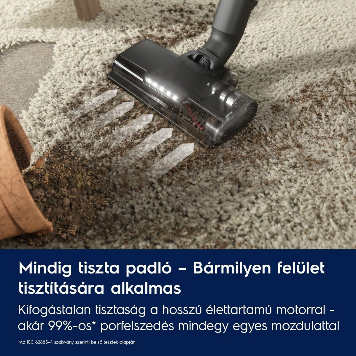 Egy porszívó tisztít egy szőnyeget a szennyeződéstől. Egy cserép föld van a szőnyeg mellett. A porszívó mutatja a tisztítási utat.