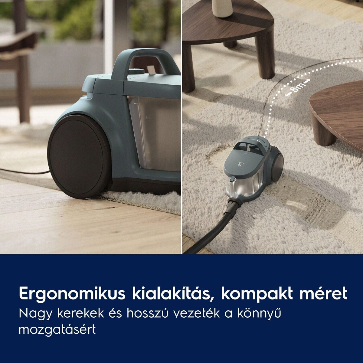 Türkiz porszívó szőnyegen, fa asztalok közelében. A kábel 8 m-es hatótávolságot jelez.