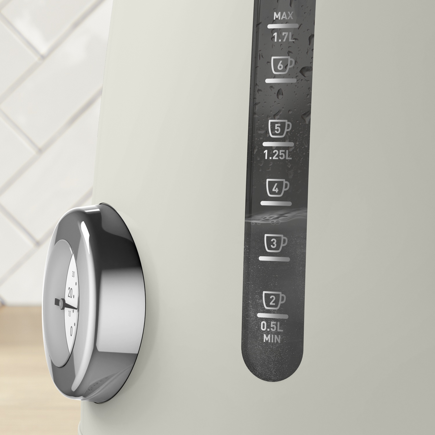 A cream-colored kettle with a water level indicator. A temperature gauge is on the side. The background shows white tiles.