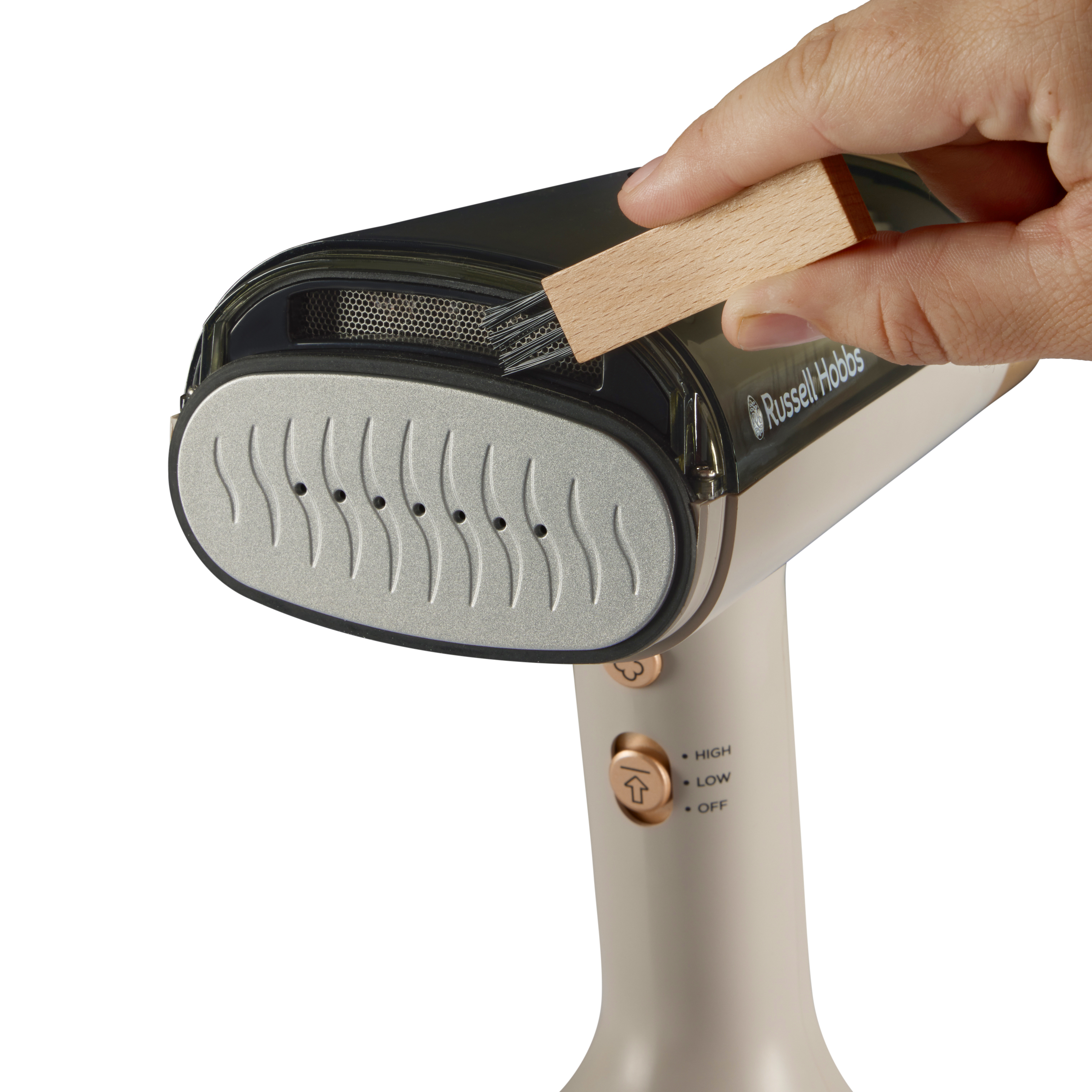 Ręka trzyma drewnianą szczotkę nad czarno-kremową parownicą do ubrań. Parownica ma przyciski wysoki, niski i wyłączony.