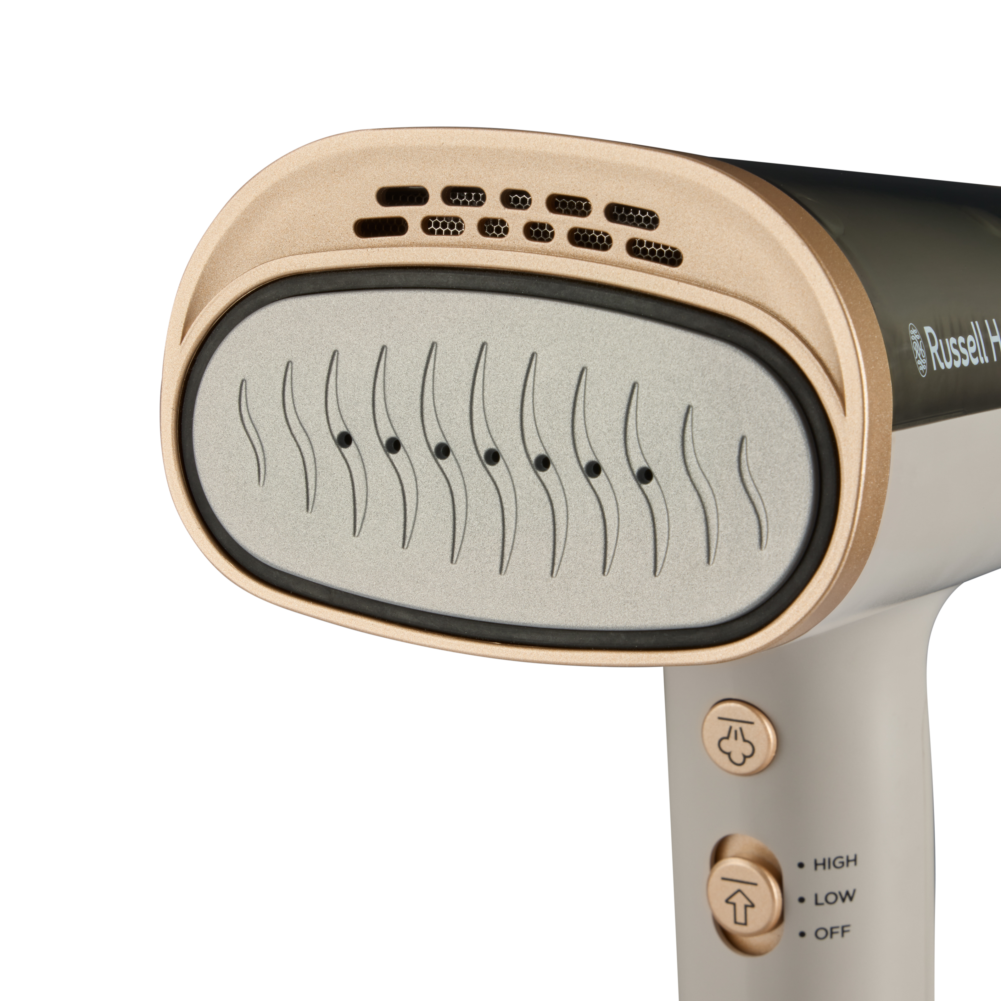 Zbliżenie parownicy ręcznej. Ma złotą głowicę z otworami parowymi. Uchwyt jest beżowy.