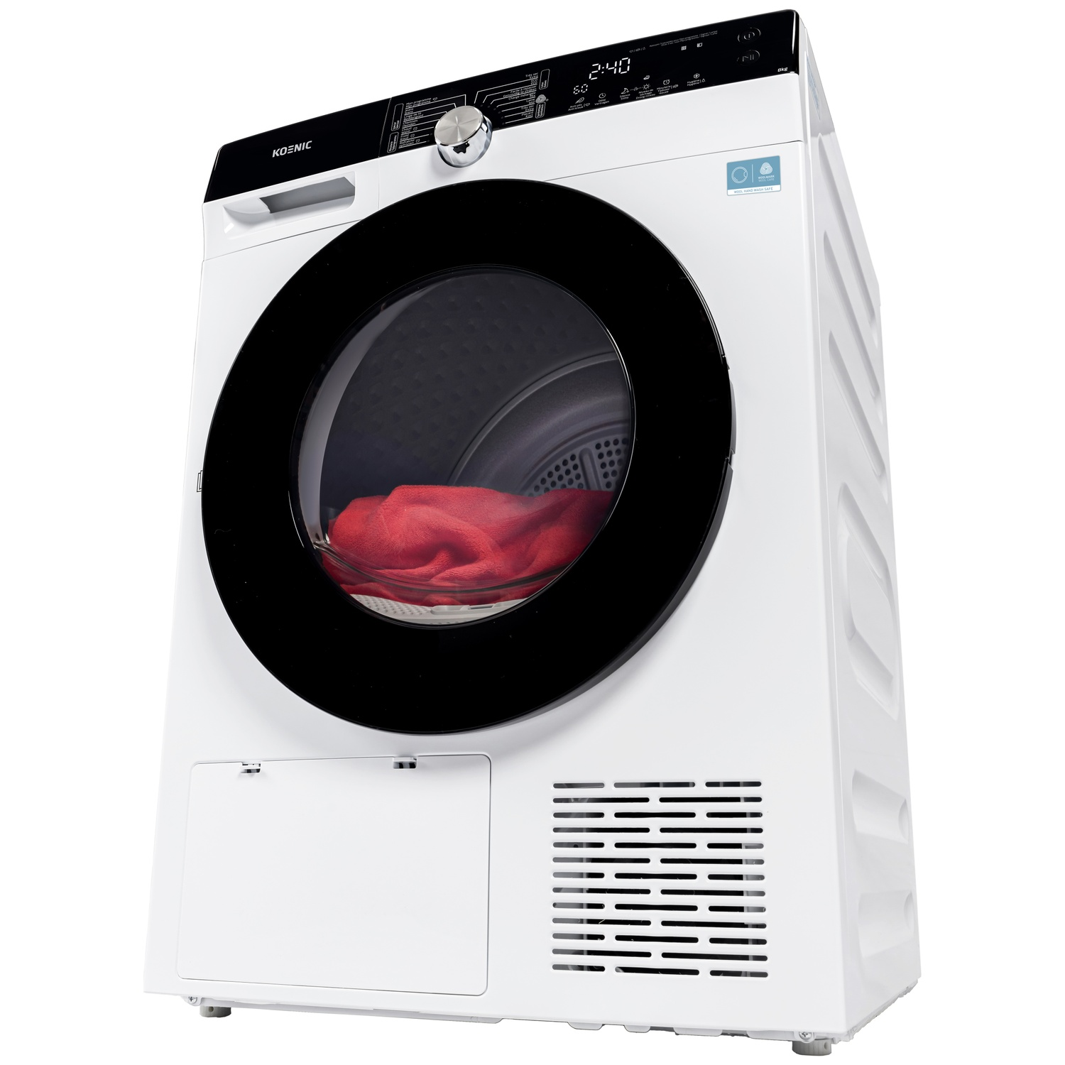 A white Koenic dryer machine with a black door. Inside, a red towel. The display shows 2:40. It has a control panel at the top.